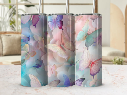 Three tumblers with pastel butterfly designs on a marble countertop.