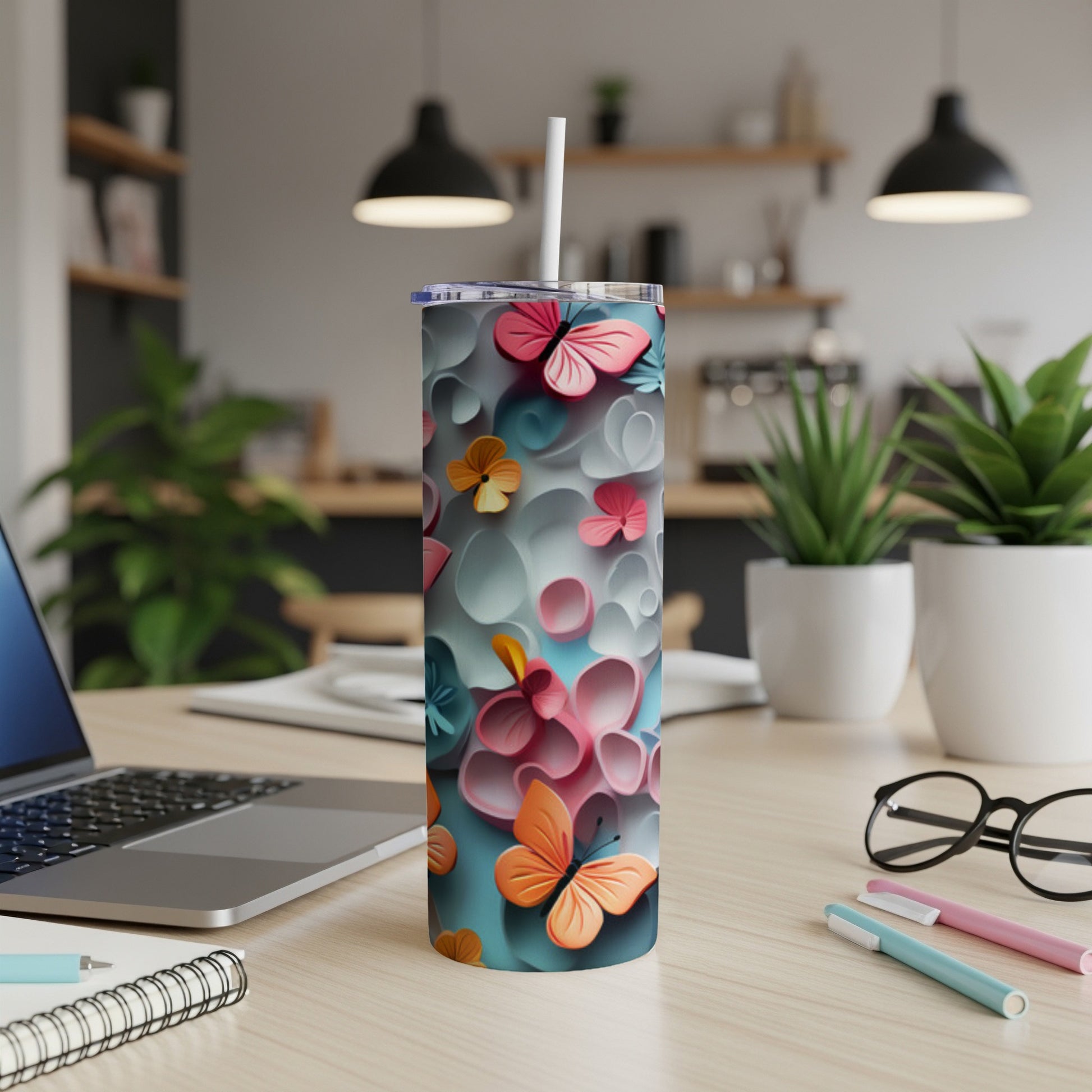 Tumbler with colorful butterflies and floral design.