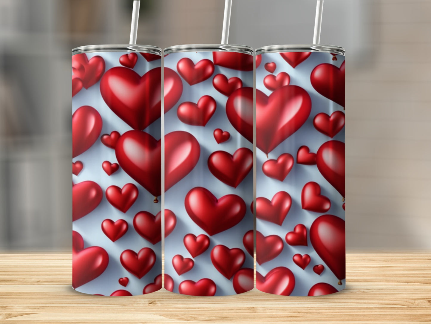 Three tumblers with a repeating red heart pattern and straw.
