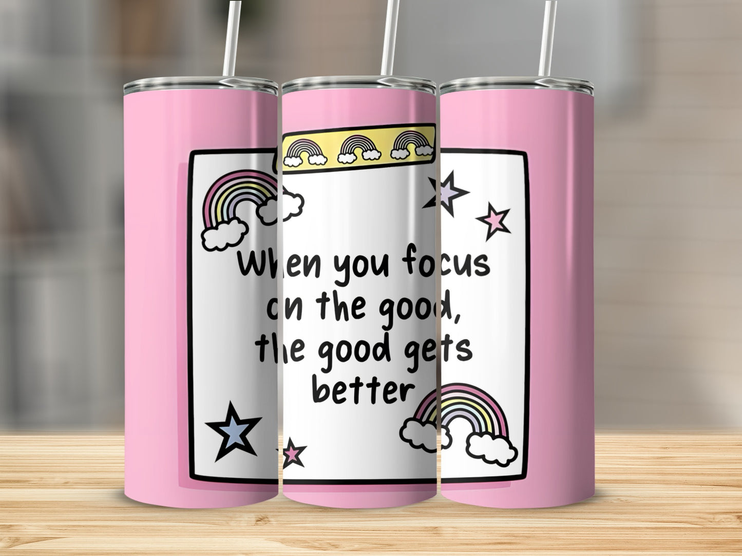 Pink tumbler with rainbow and star design, featuring text "When you focus on the good, the good gets better".