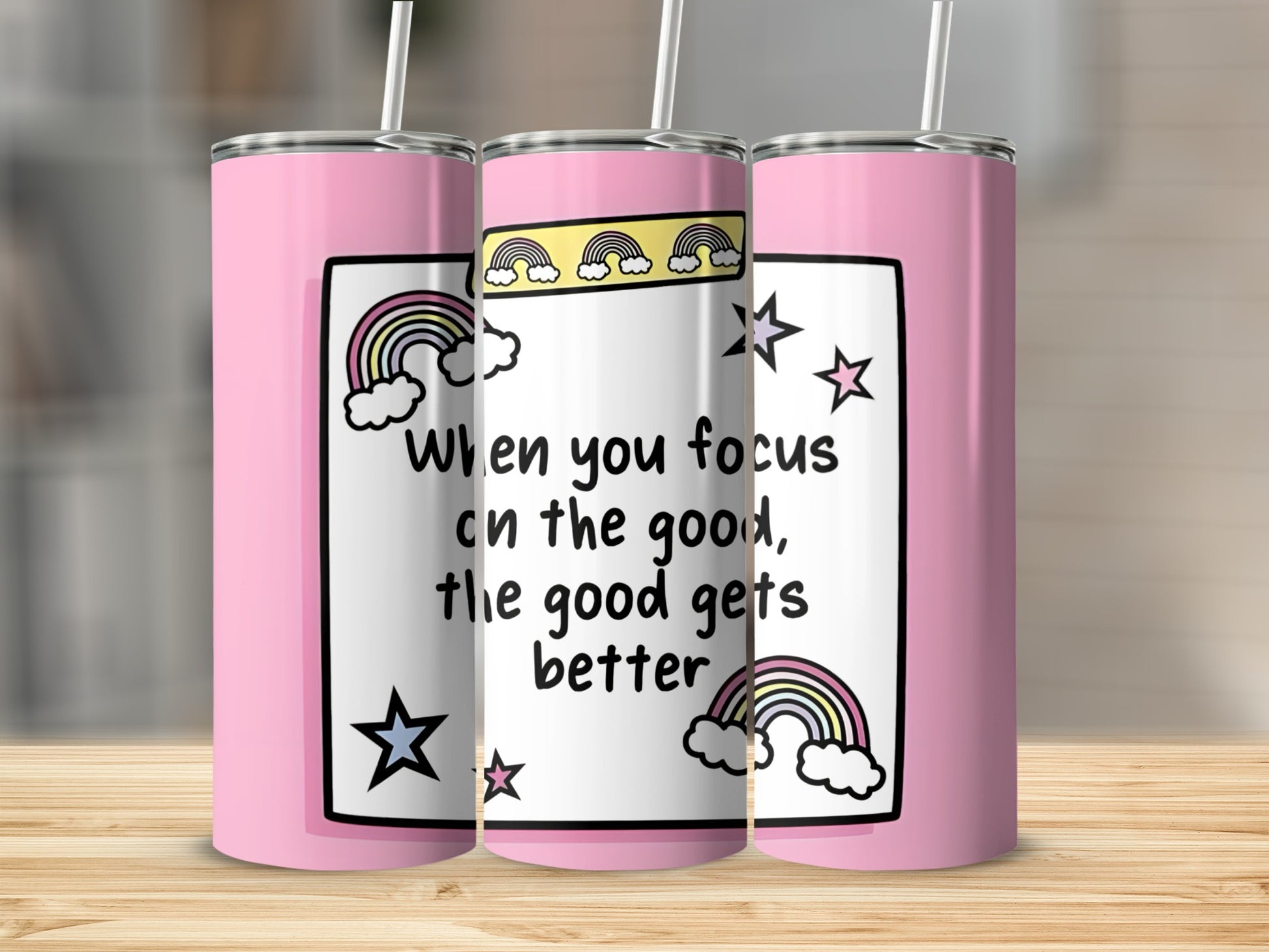 Pink tumbler with rainbow and star design, featuring text "When you focus on the good, the good gets better".