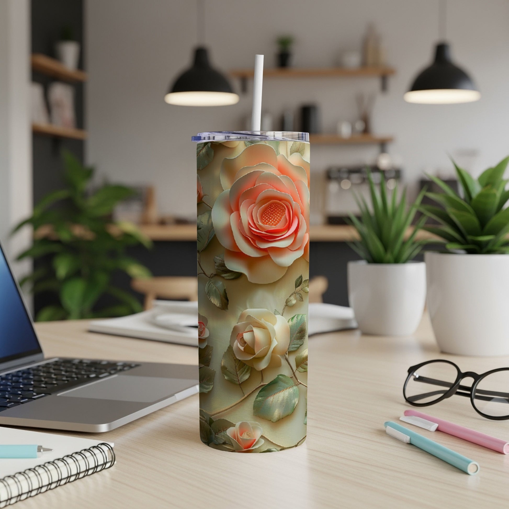 Creamy floral tumbler with a straw on a desk.