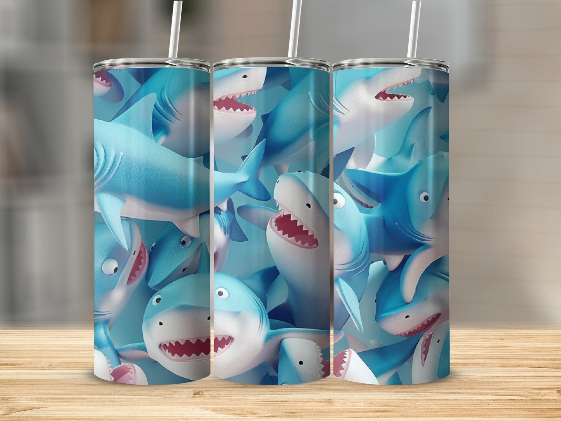 Three blue tumblers with a pattern of cartoon sharks.