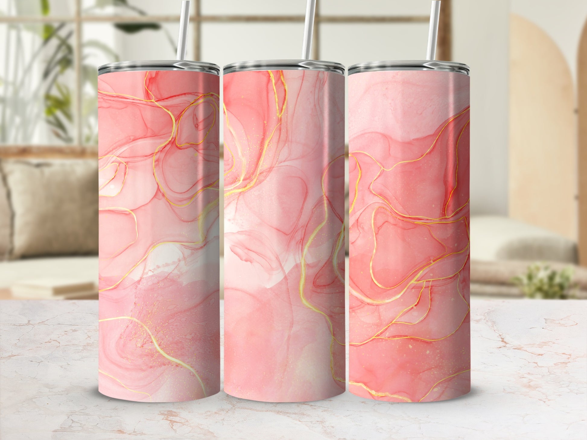 Three tumblers with a pink and gold marble-like design.