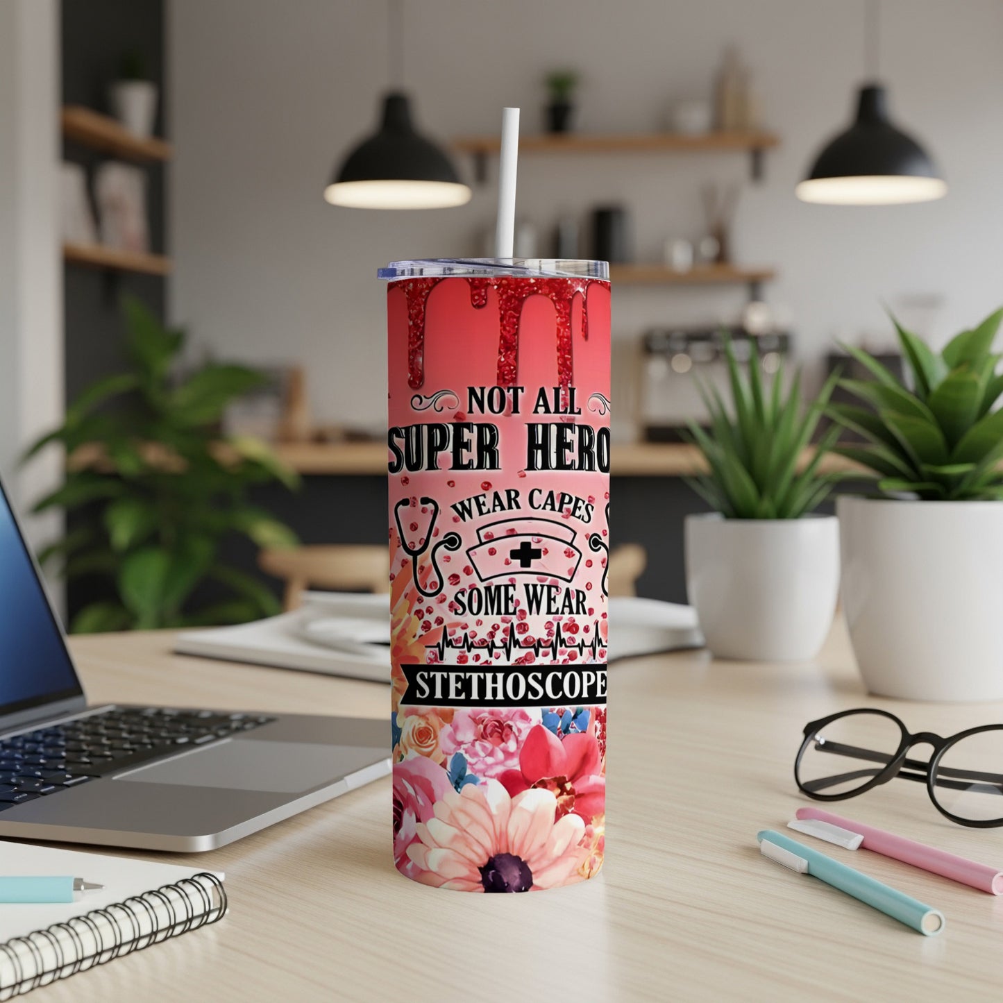 Glittery tumbler with "Not All Heroes Wear Capes, Some Wear Stethoscopes" text and floral design.