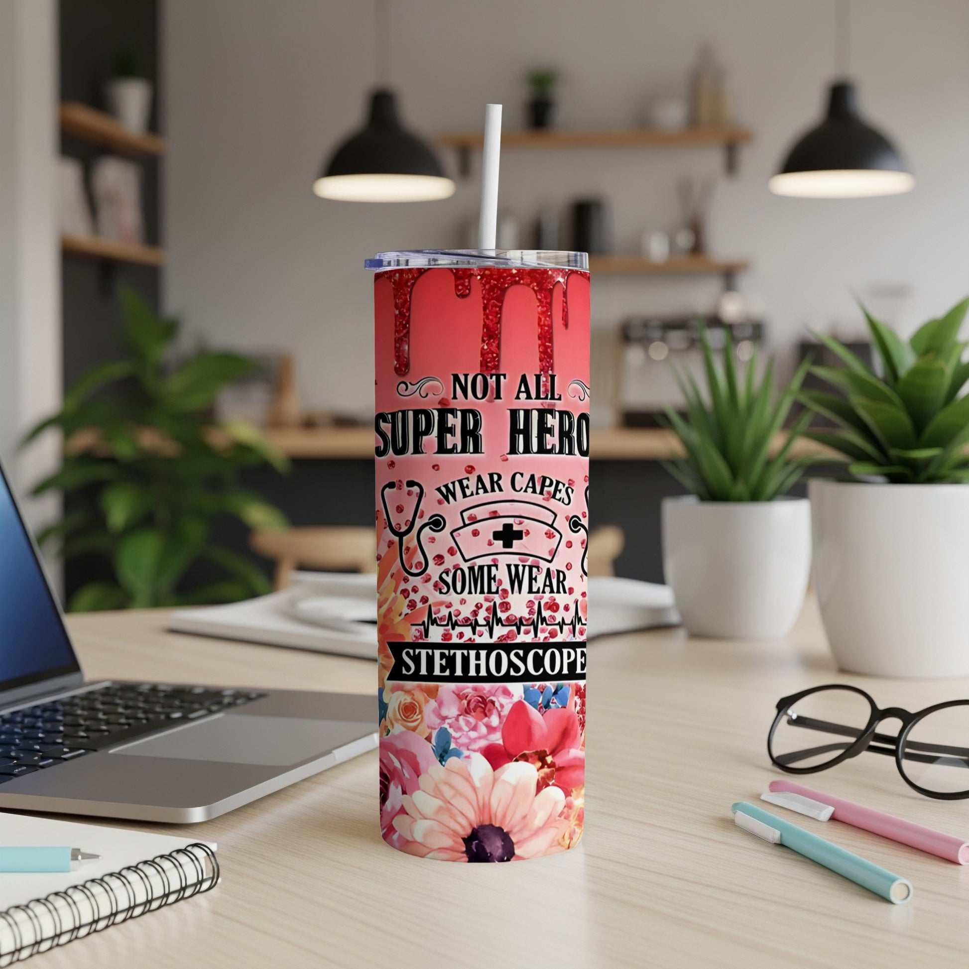 Glittery tumbler with "Not All Heroes Wear Capes, Some Wear Stethoscopes" text and floral design.