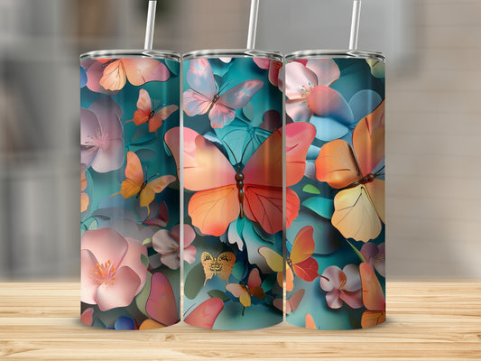 Three tumblers with a vibrant floral and butterfly design.