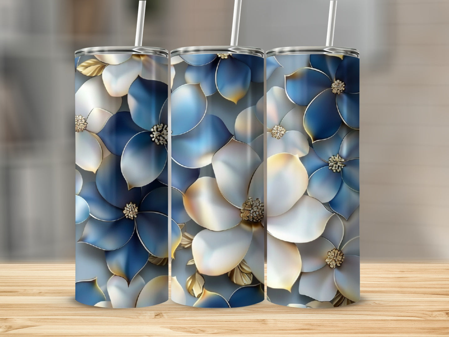 Three tumblers with a blue and white floral design and gold accents.