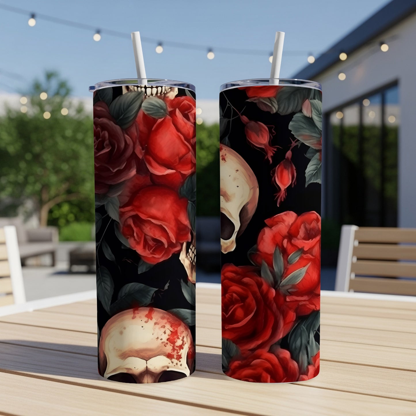 Two tumblers with a dark floral and skull design sit on a table.