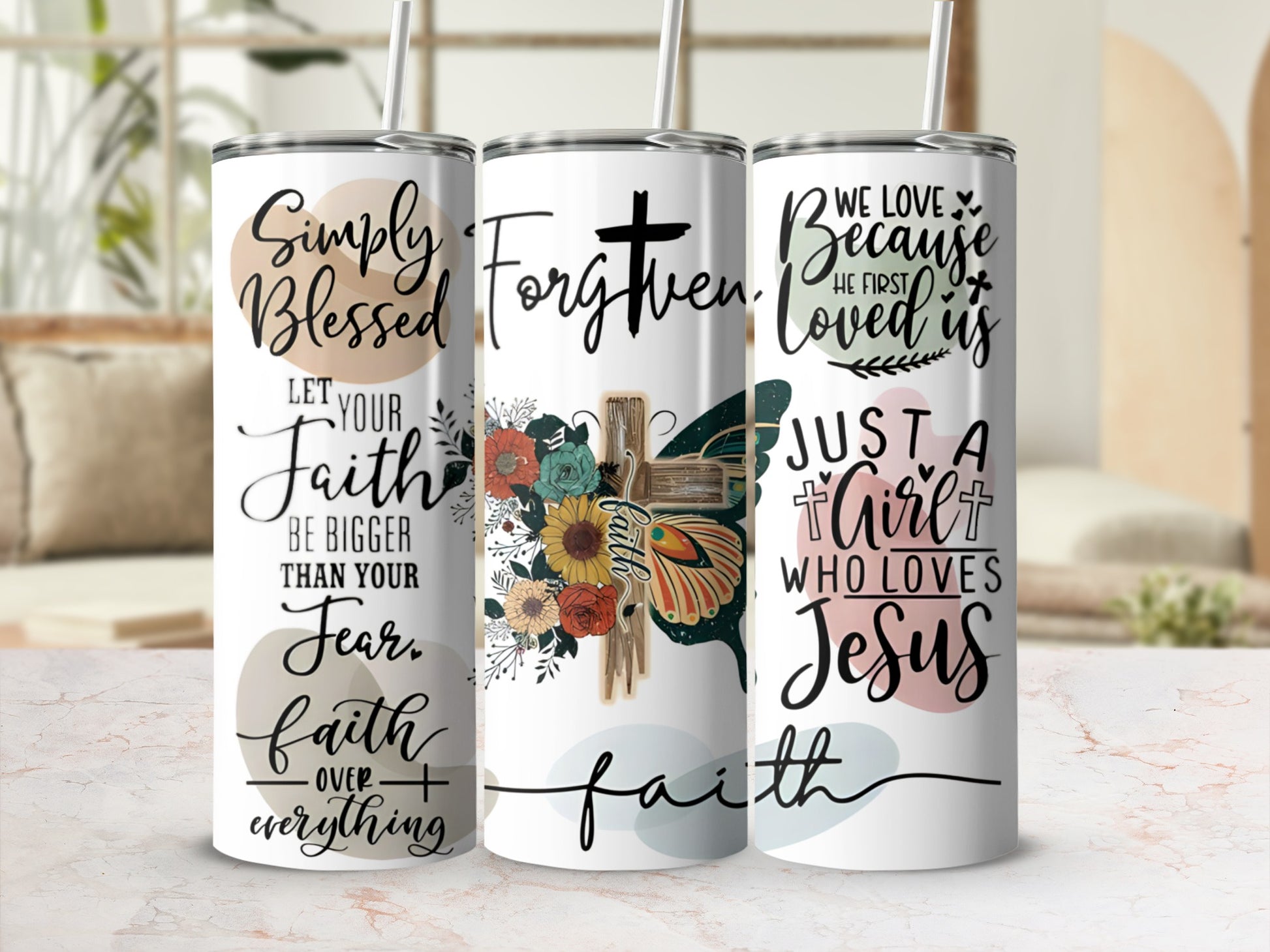 Three tumblers with inspirational quotes and floral designs.
