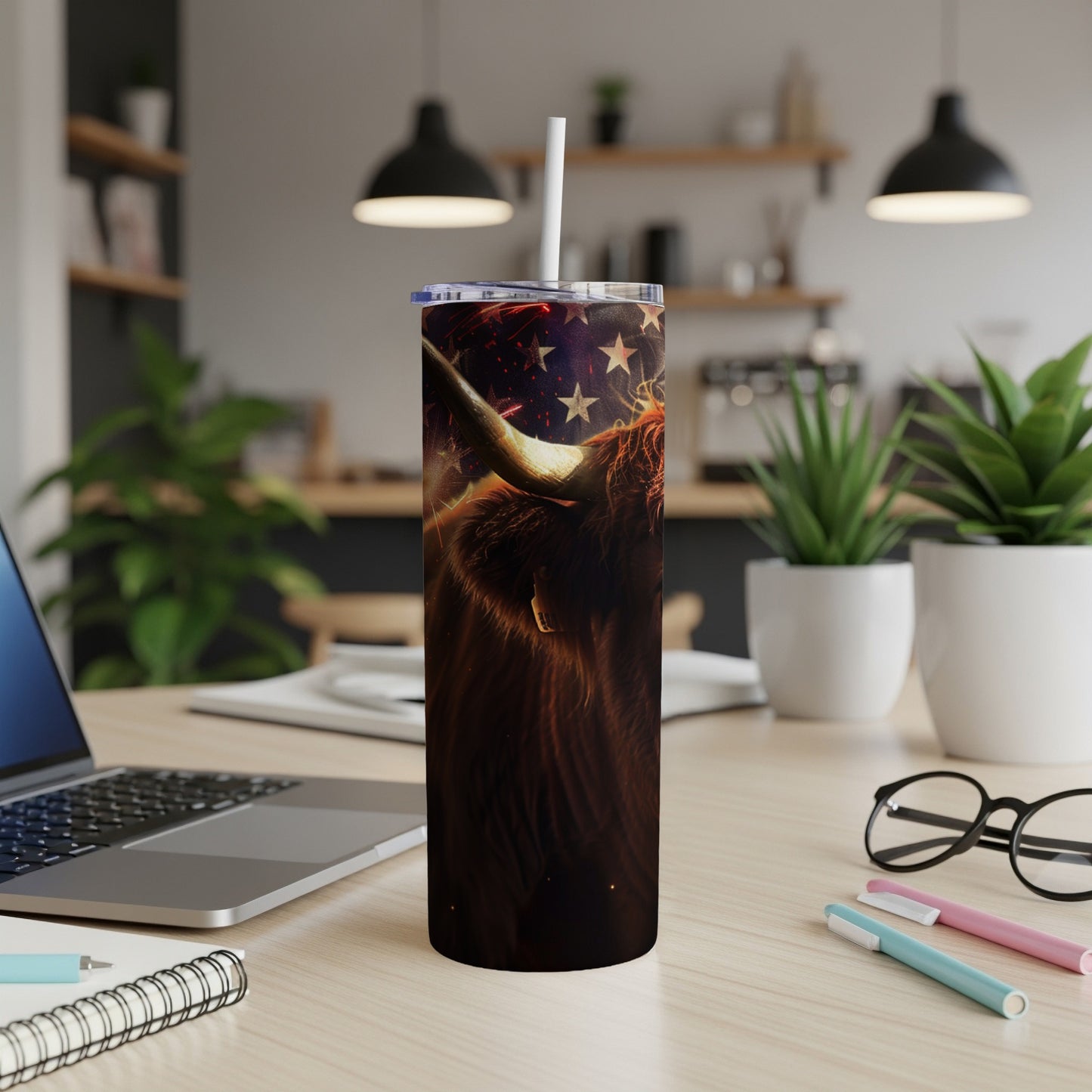Highland cow on patriotic background, patriotic tumbler cup on desk.