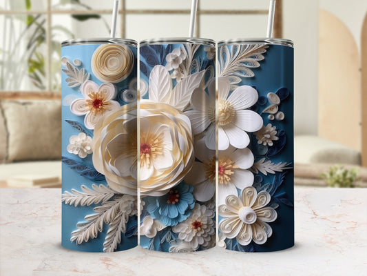 Blue tumbler with intricate white and blue paper flower floral design.
