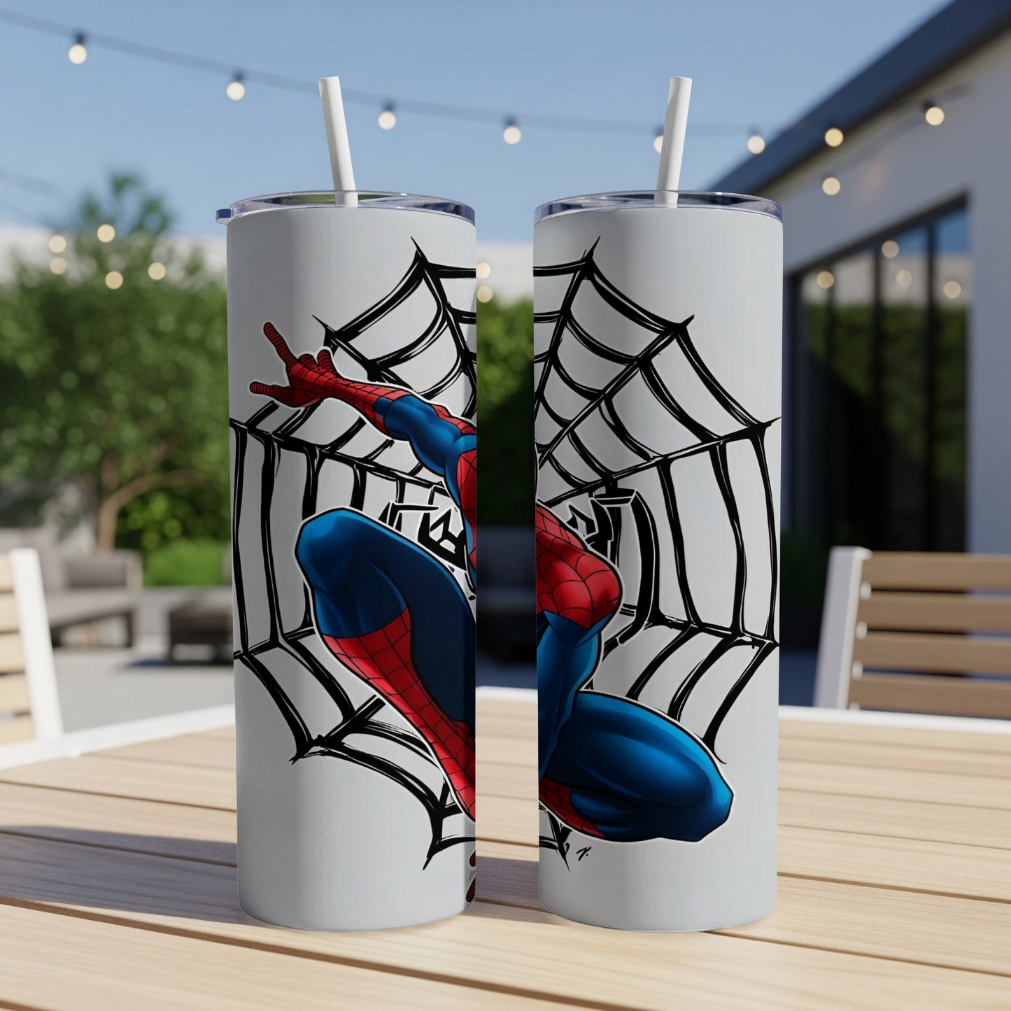 Spider-Man in web on white tumbler with straw, outdoors.