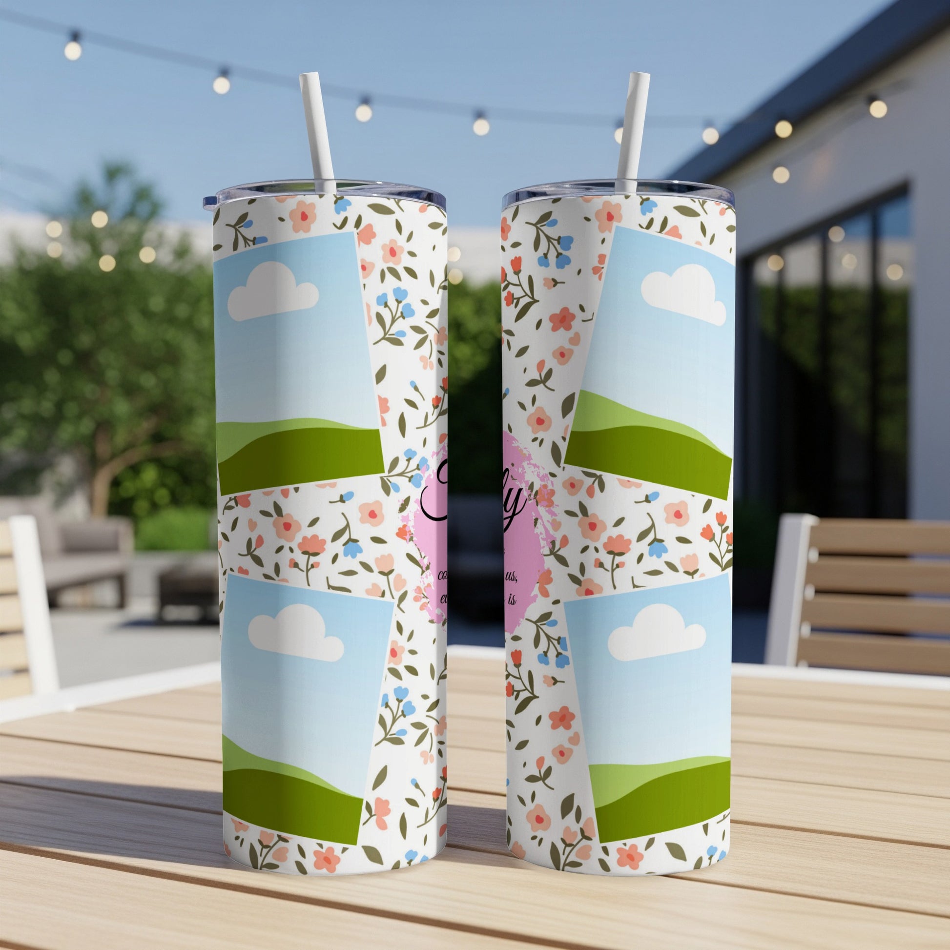 Two tumblers with floral pattern and personalized text sit on a table.