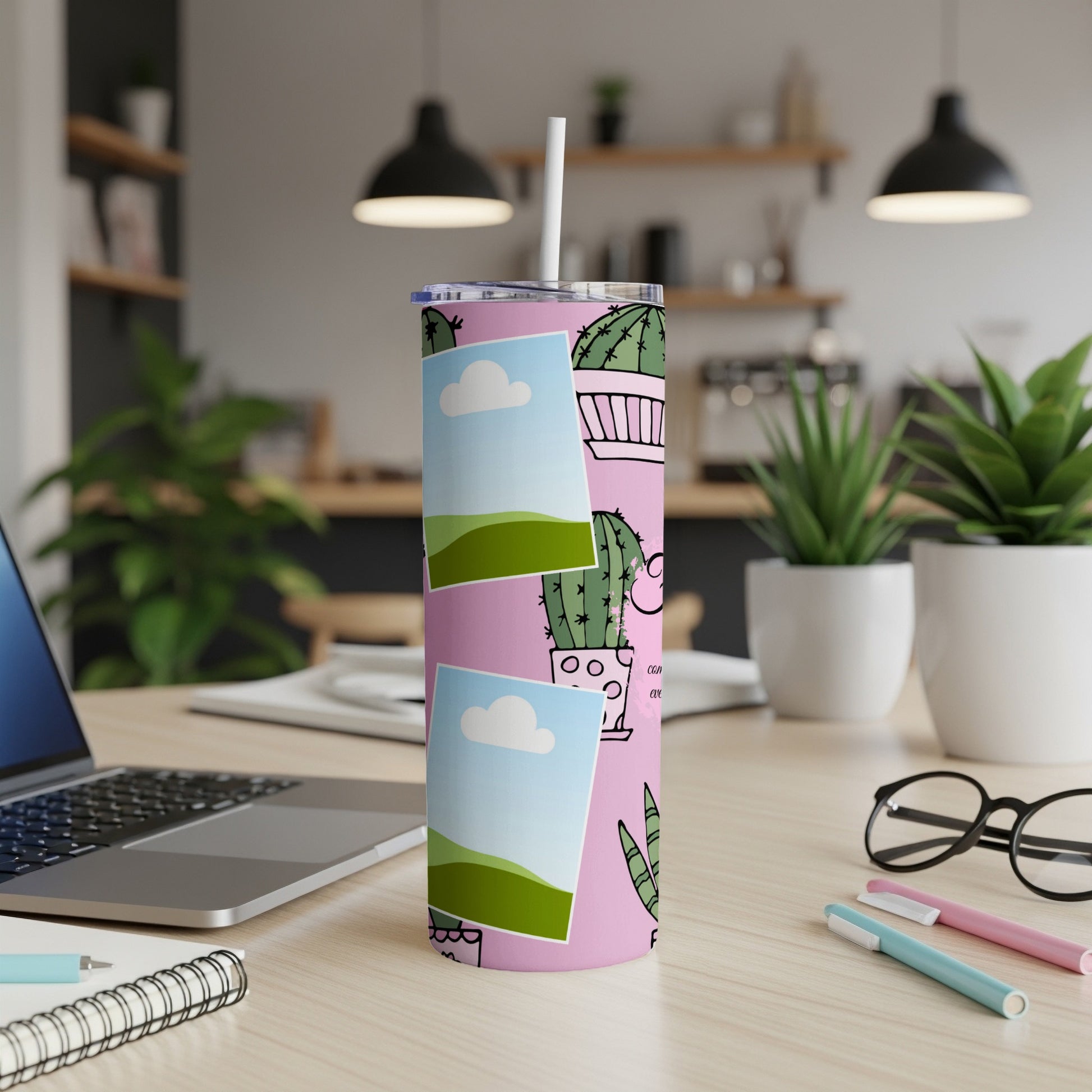 Pink tumbler with cactus pattern and scattered photo frames.