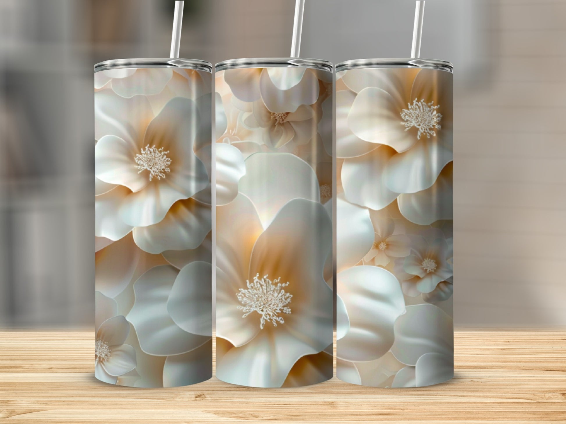 Three tall tumblers with a creamy white floral pattern on a wooden surface.