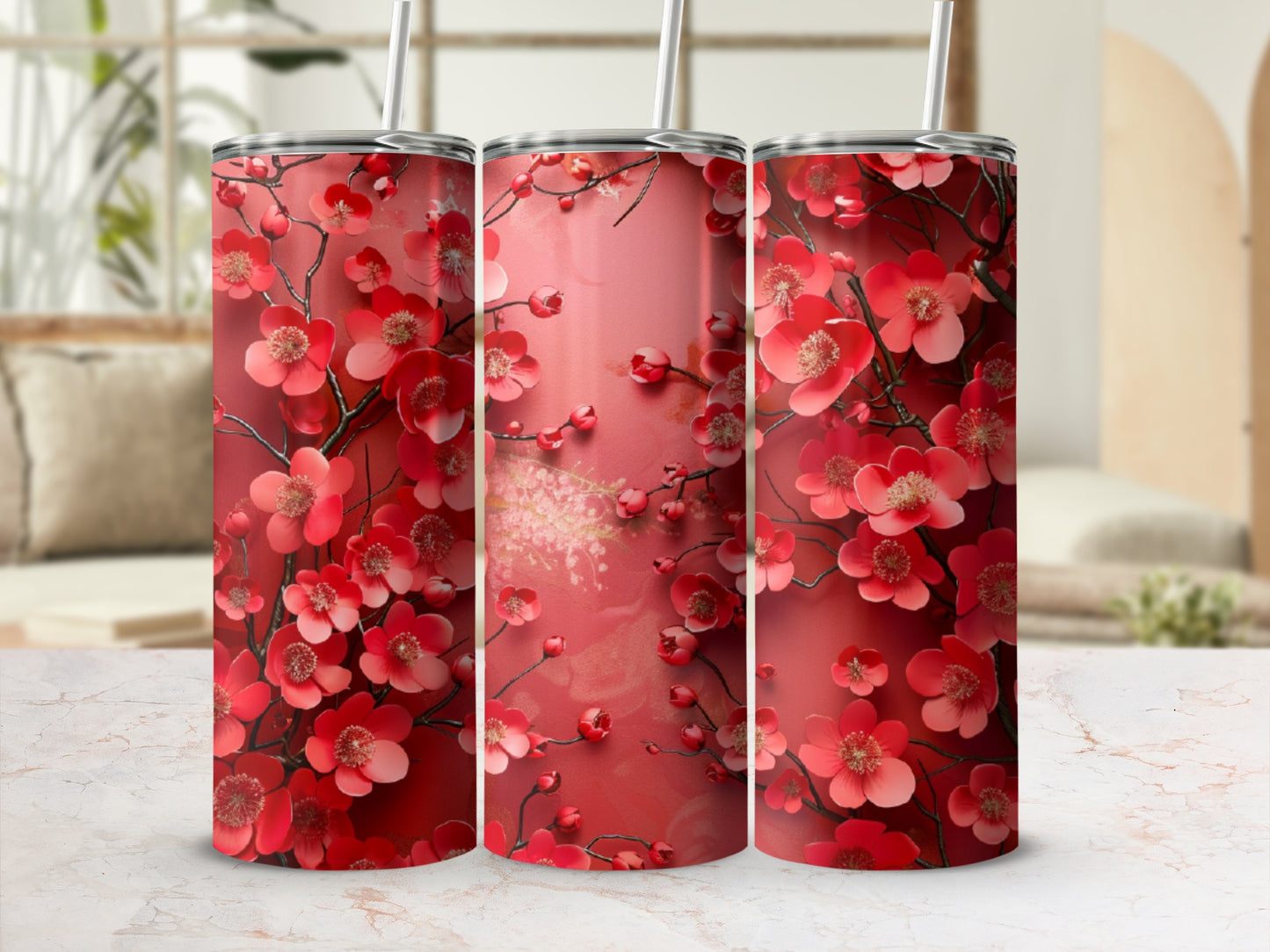 Three tumblers with a red floral pattern and white straws.