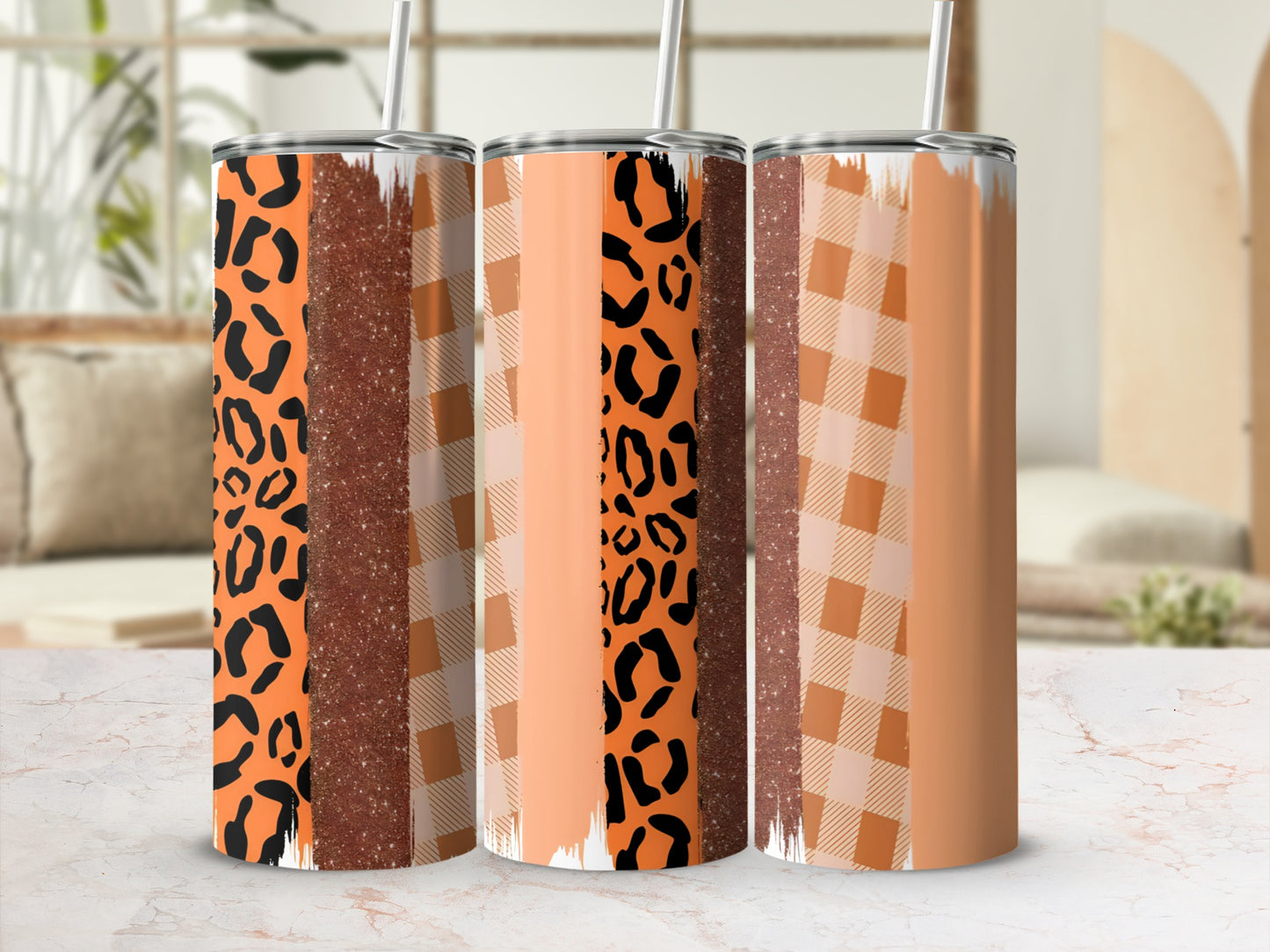 Three tumblers with leopard print, glitter, and plaid patterns.
