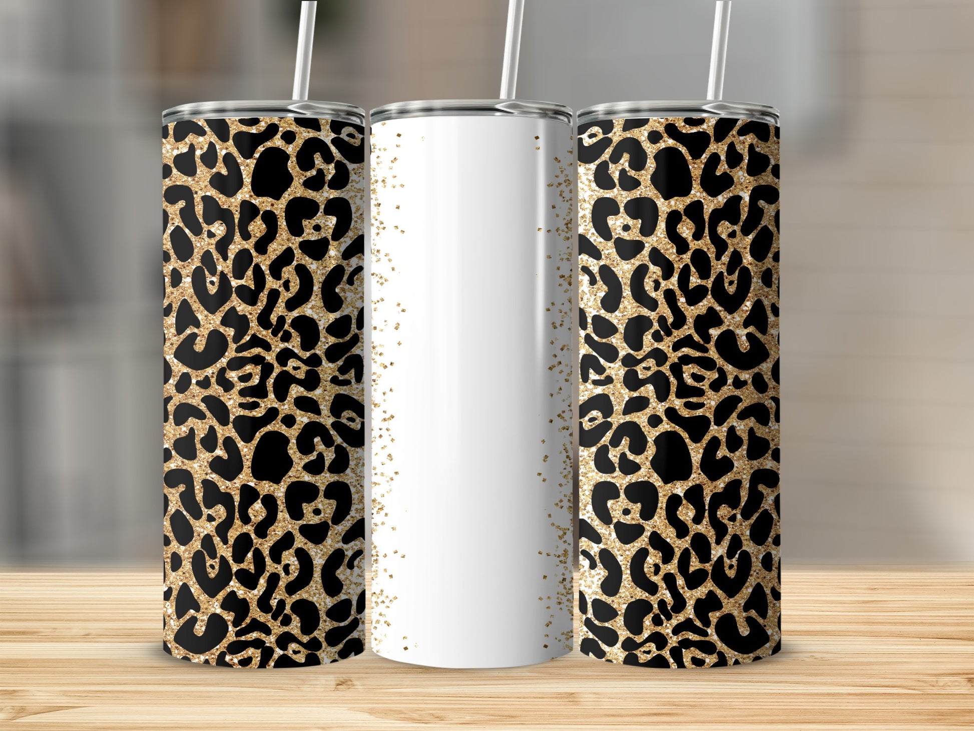 Three leopard print tumblers with gold glitter accents and white sections.