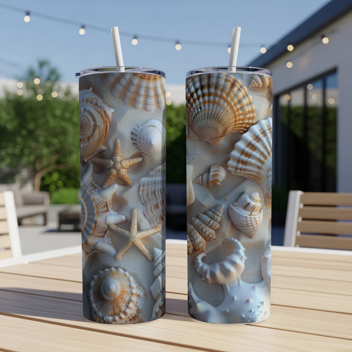 Two tumblers with seashells and starfish design on a sandy beach.