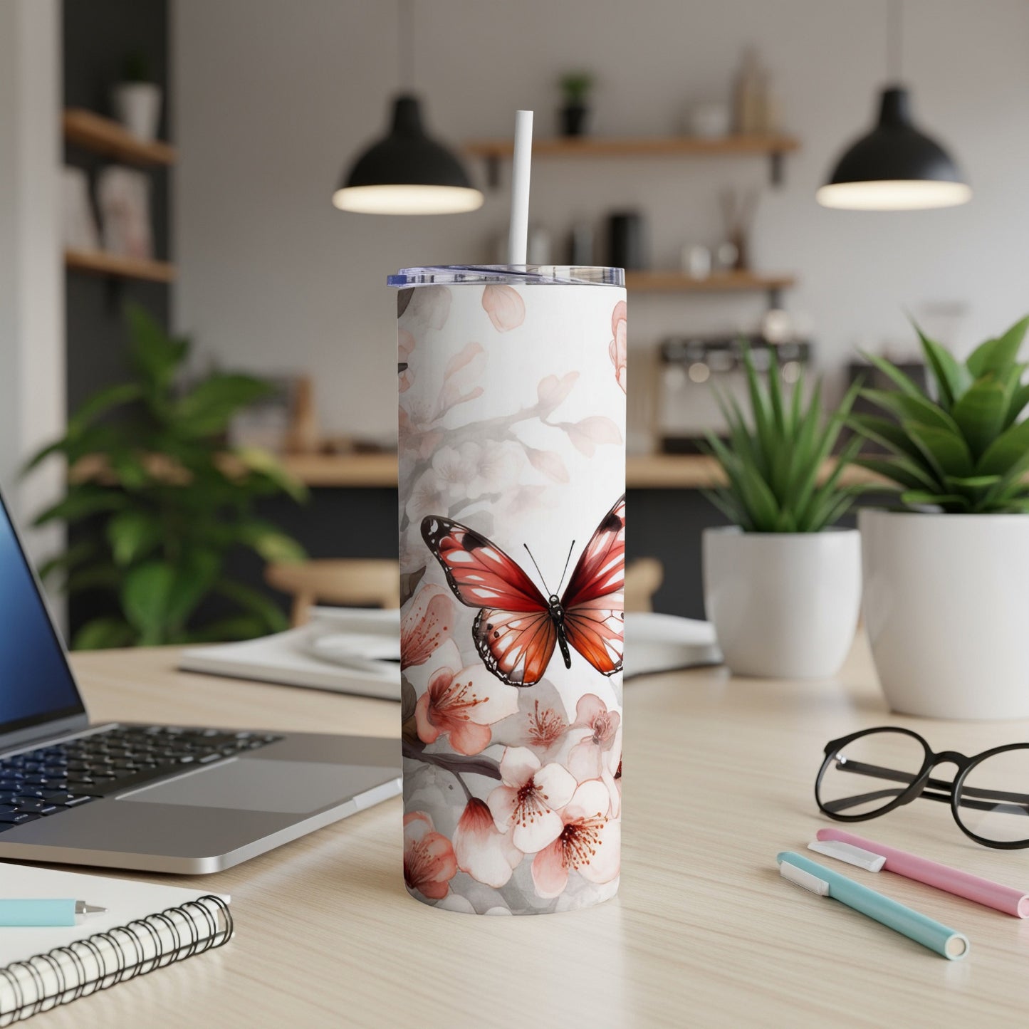 Tumbler with pink cherry blossoms and a red butterfly design.
