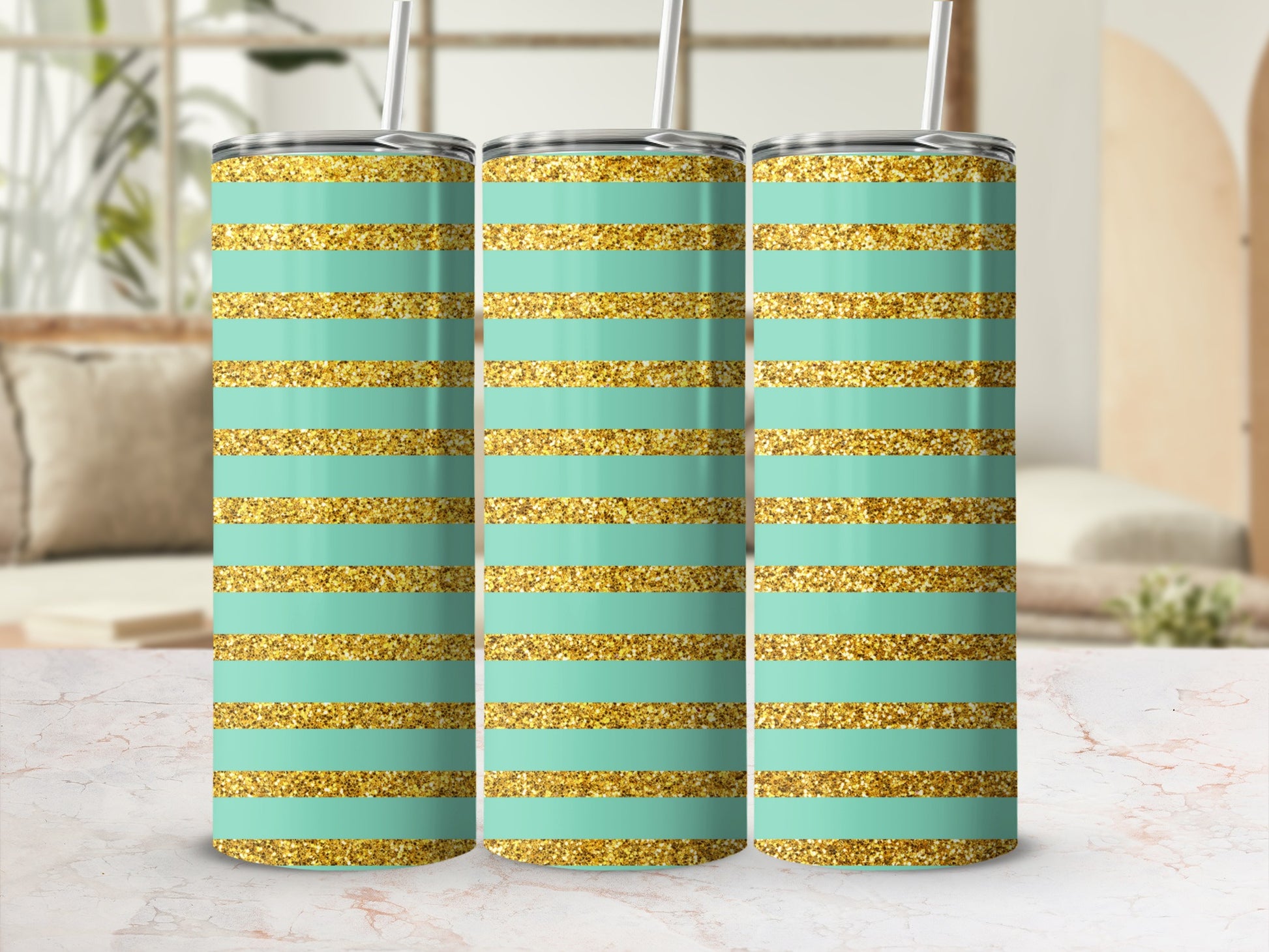 Three mint green tumblers with gold glitter stripes, each with a straw.