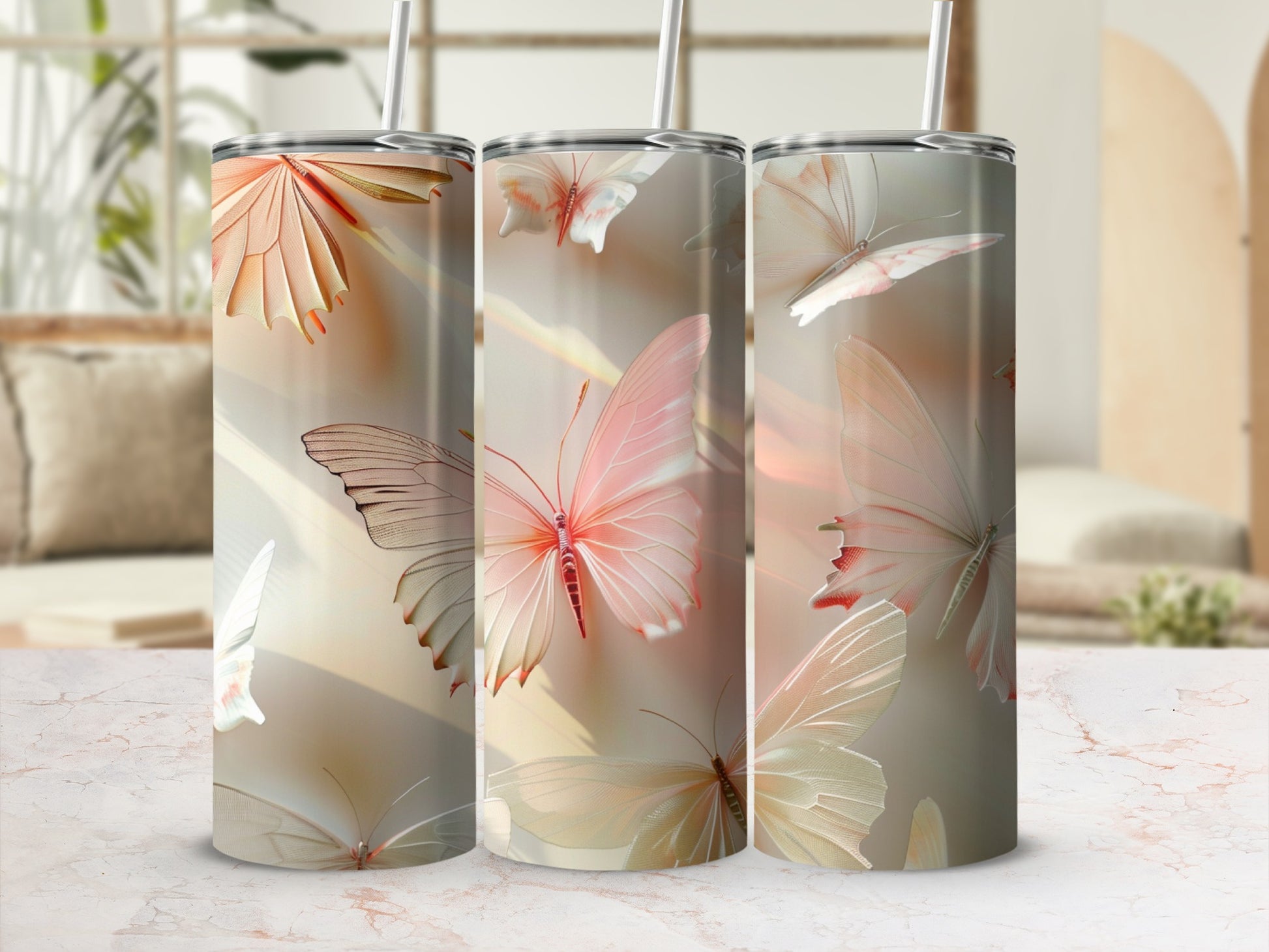 Three tumblers with soft pink butterfly designs on a marble surface.