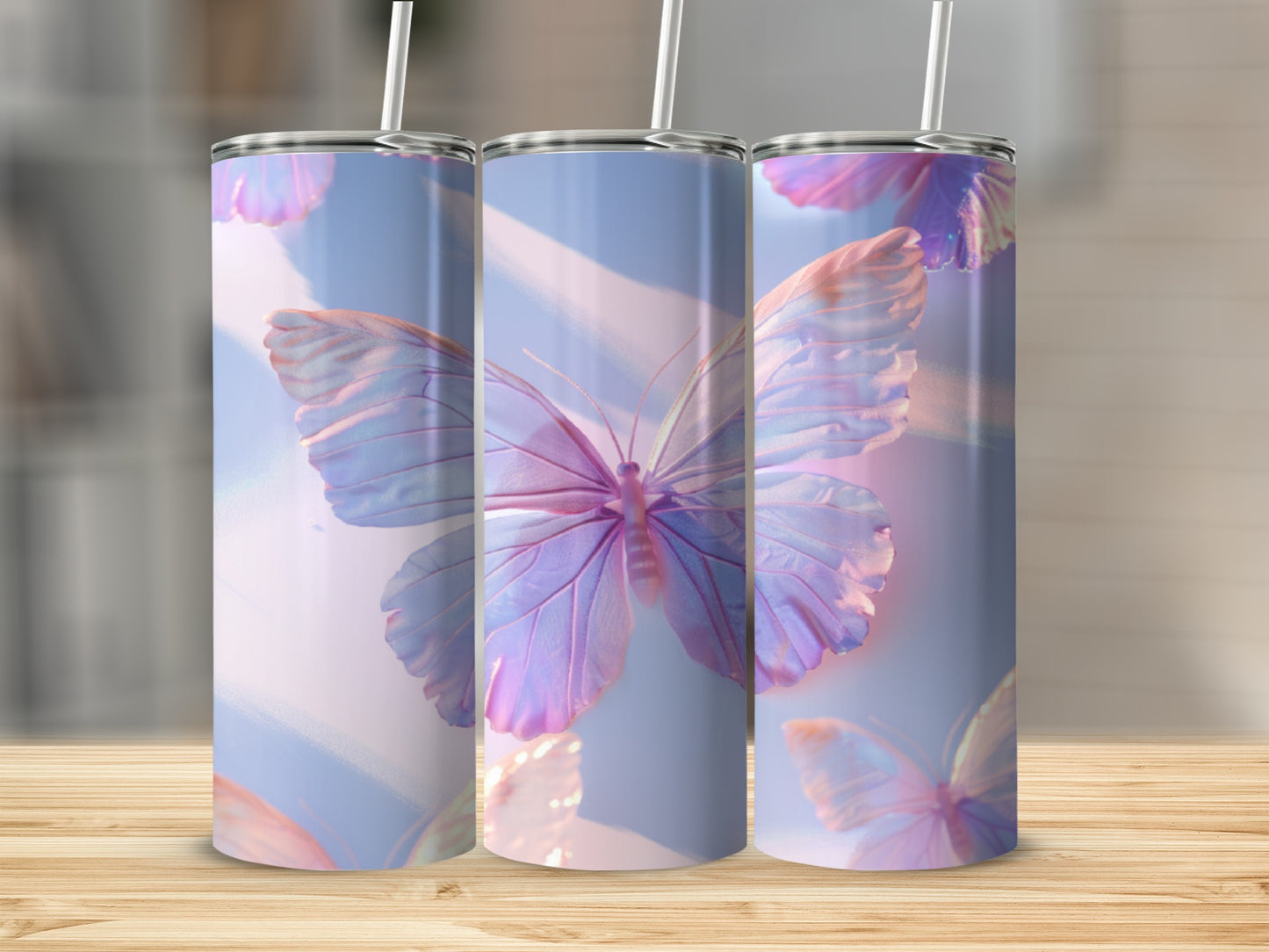 Three tall tumblers featuring iridescent butterflies against a soft, abstract background.