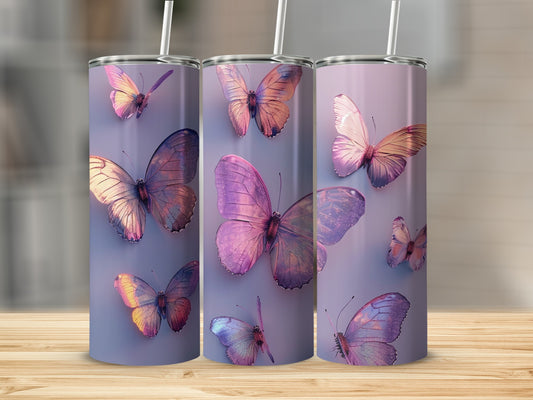 Three purple butterfly tumblers with straws on a wood surface.