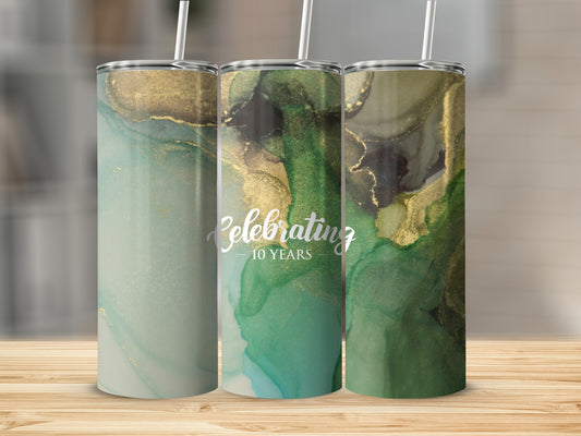 Three tumblers with abstract green and gold watercolor designs and "Celebrating 10 Years" text.