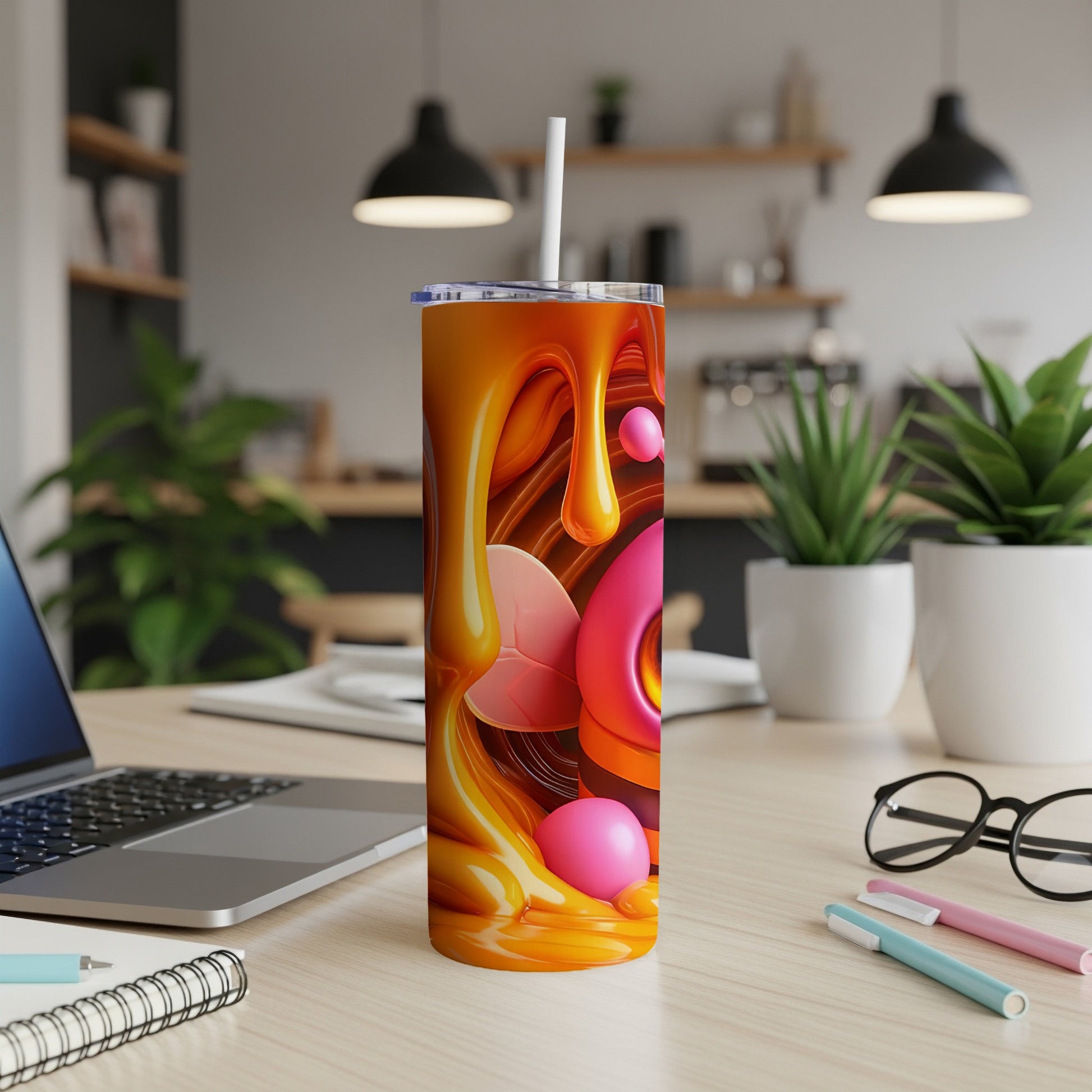 Abstract orange liquid art with pink bubble accents on a tumbler.