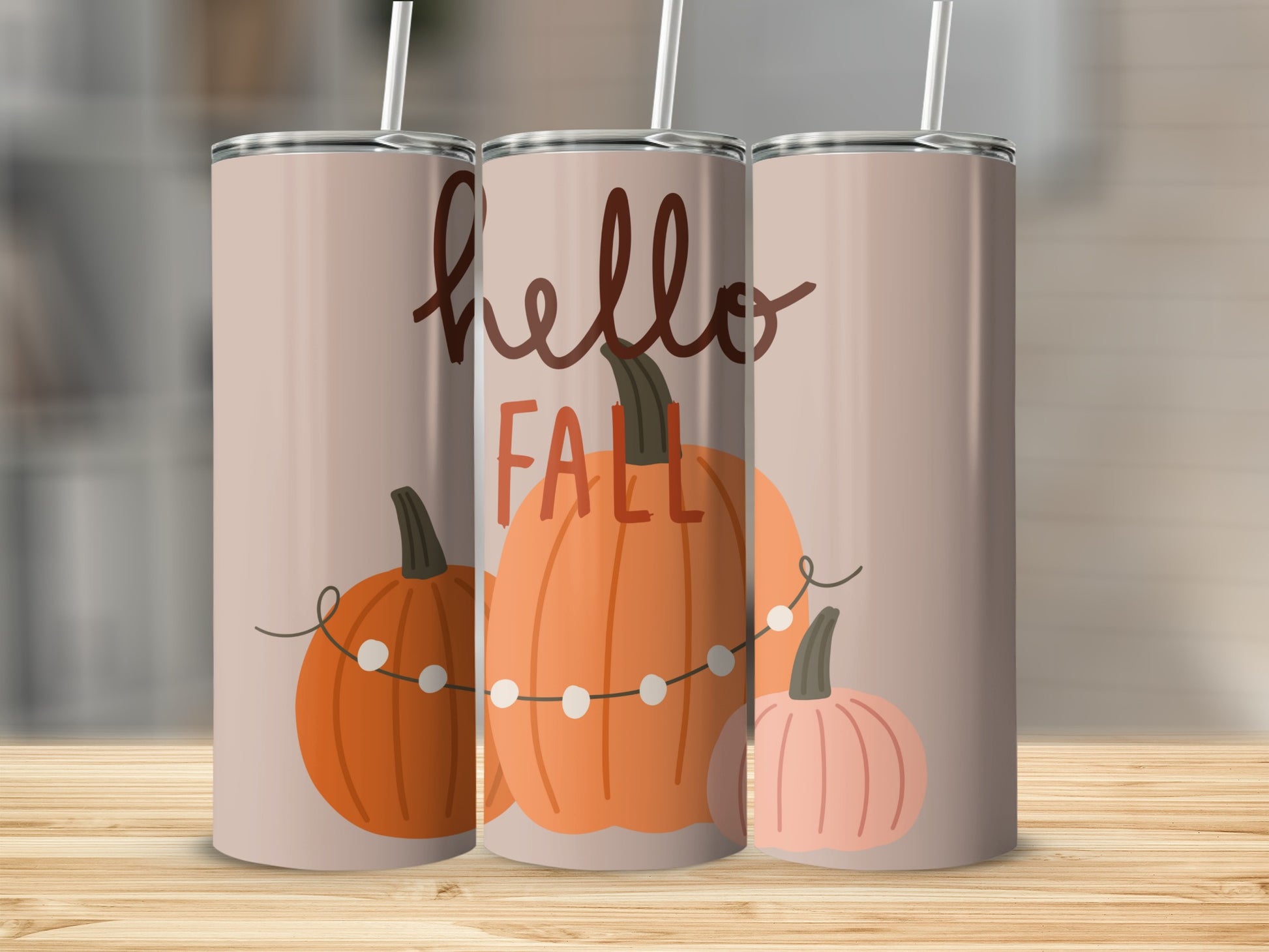 Three tumblers with pumpkins and string lights, reading "hello FALL".