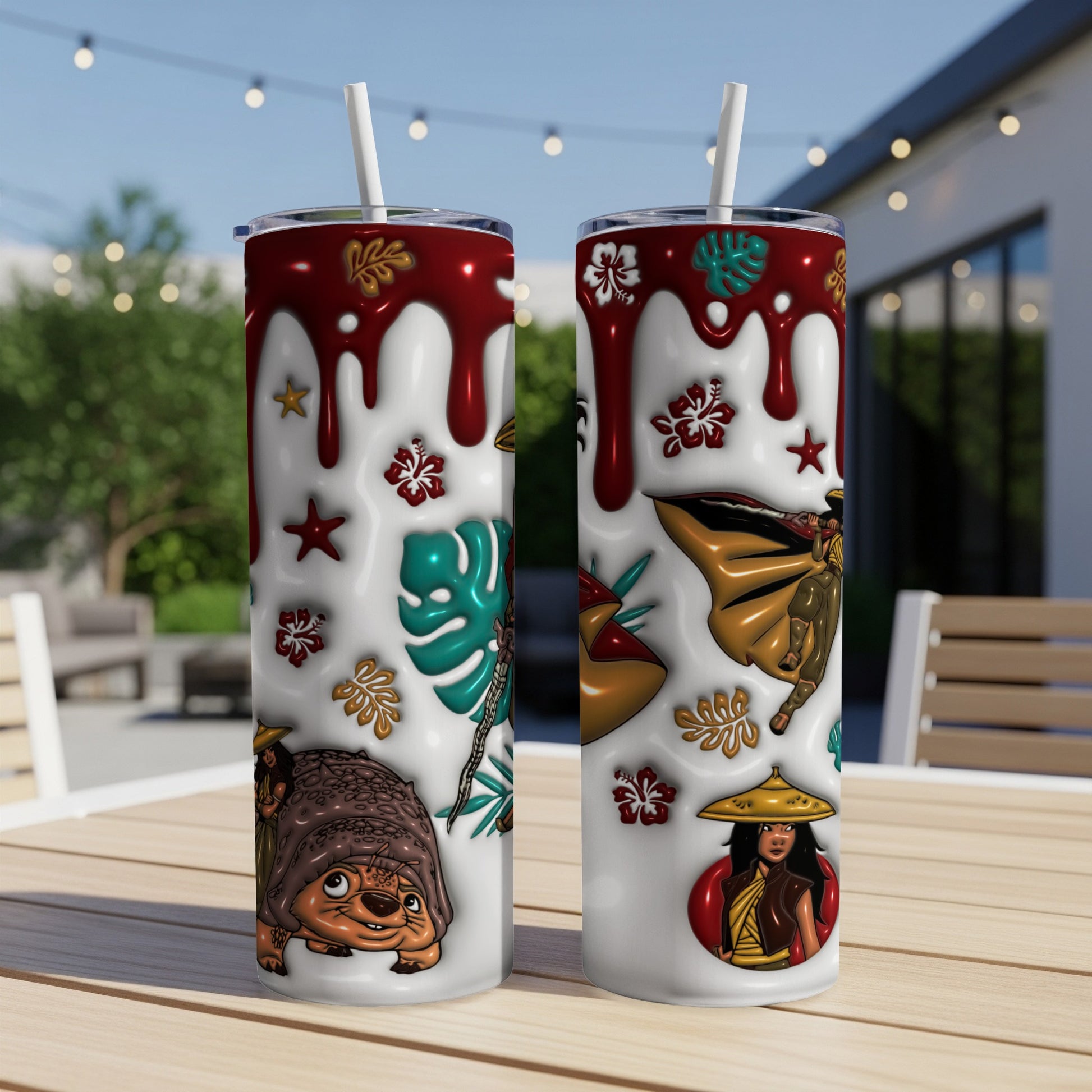 Two tumblers with characters and tropical motifs on a wooden table outdoors.