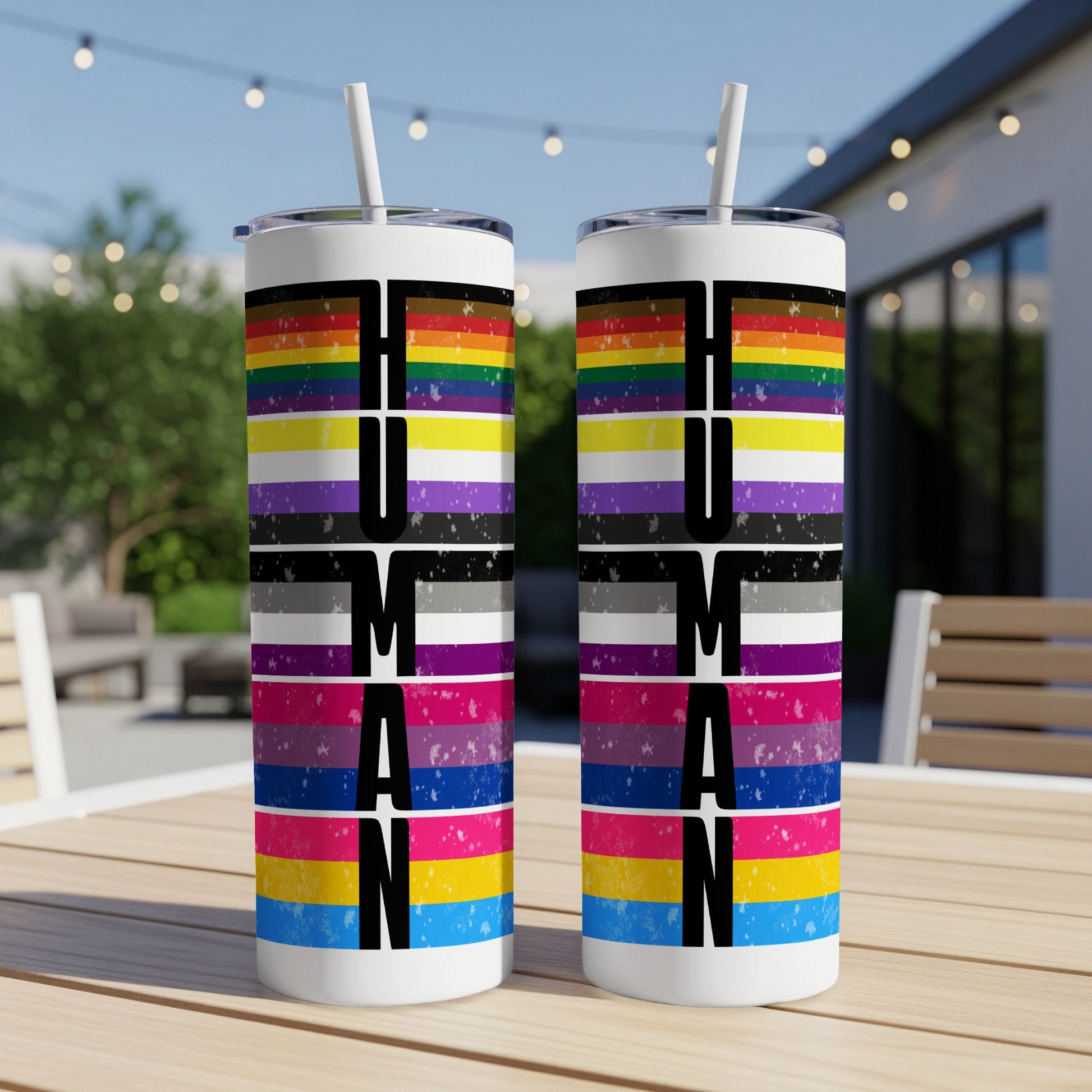 Two tumblers with LGBTQ+ pride flags spelling "HUMAN".