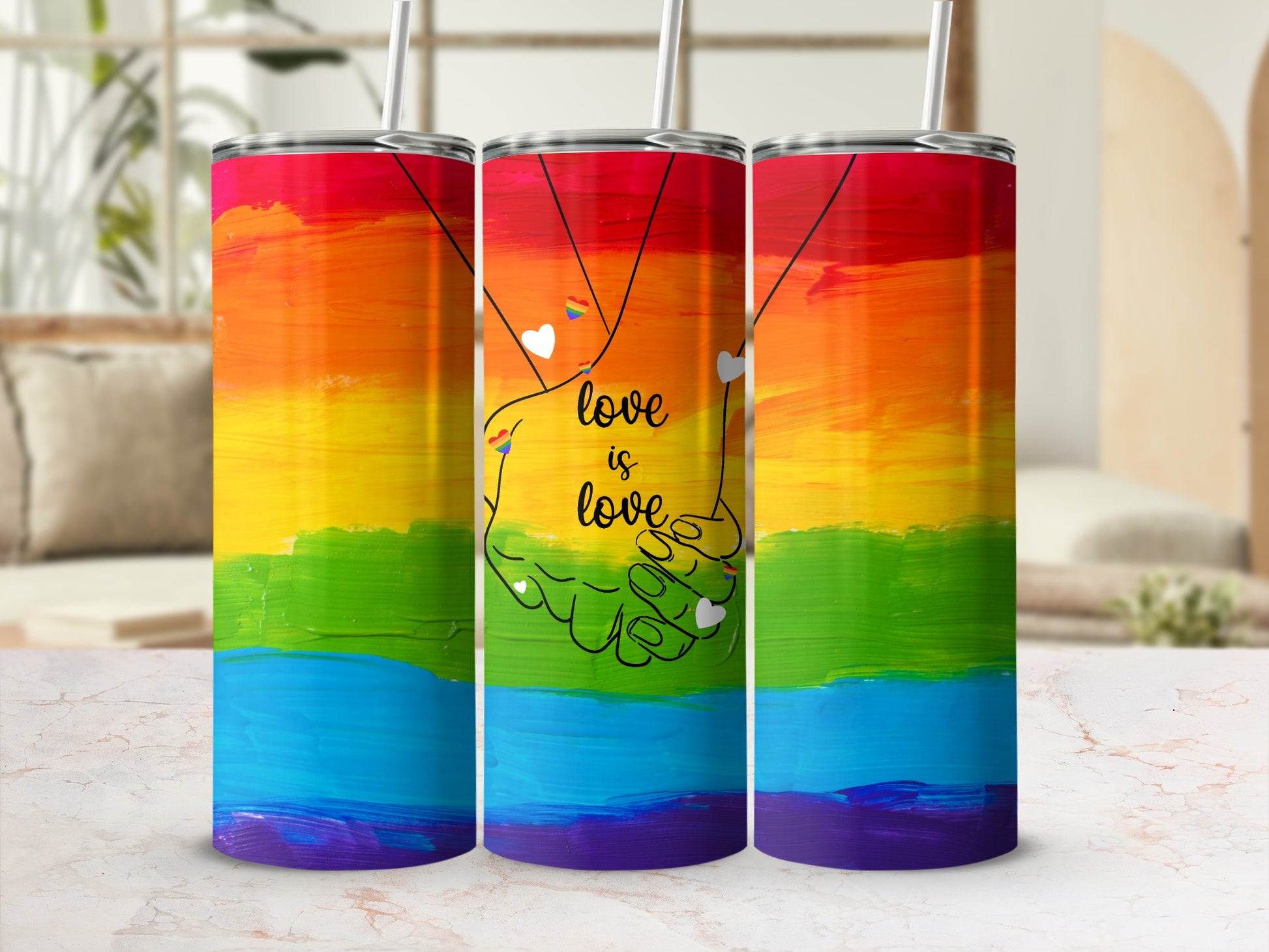 Rainbow tumbler with "love is love" text and intertwined hands graphic.