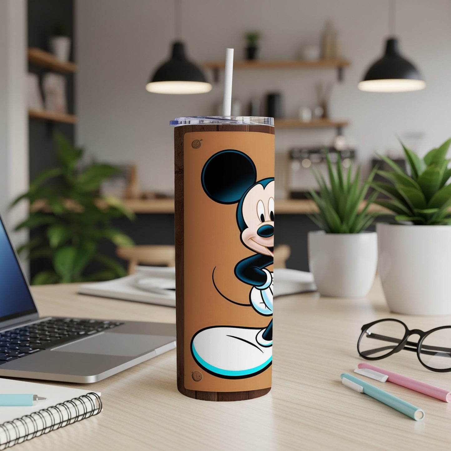 Mickey Mouse standing on a brown tumbler with a white straw.