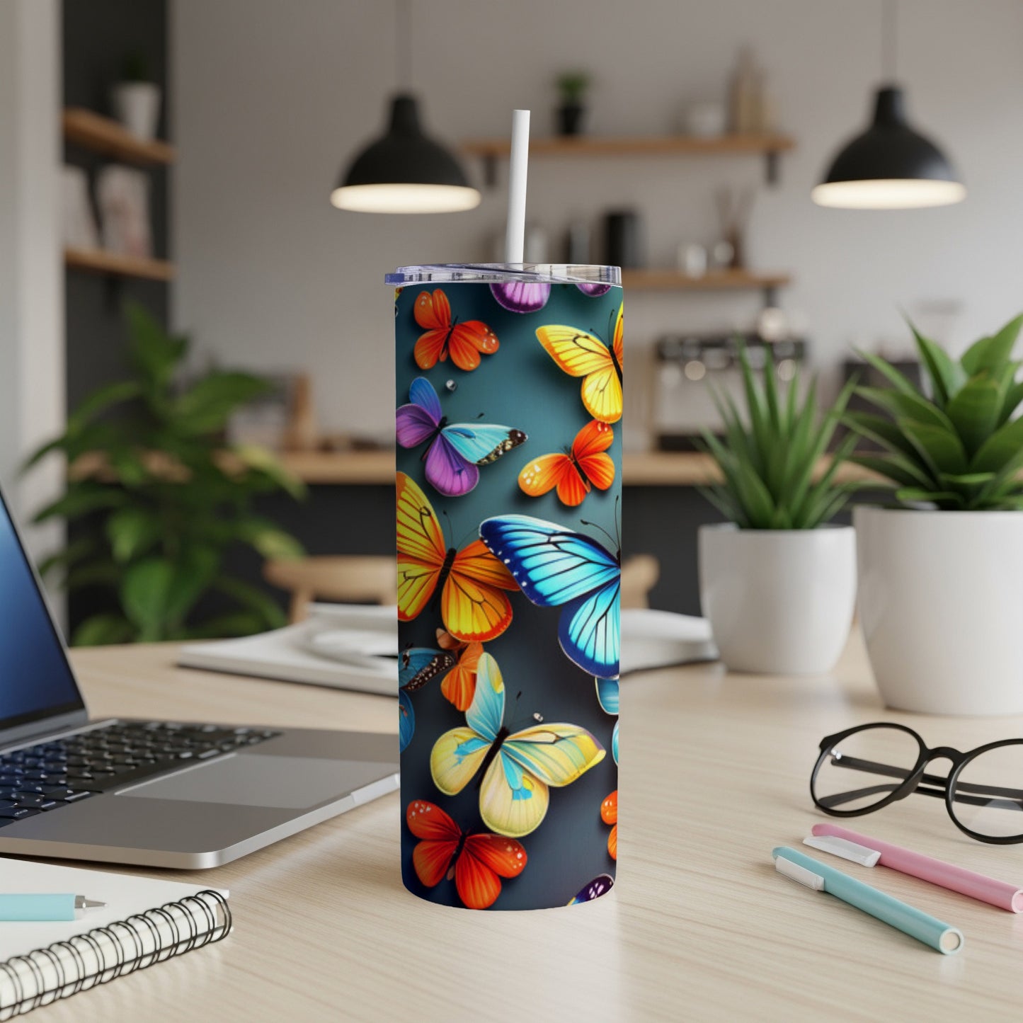 Tumbler with colorful butterflies on a dark background.