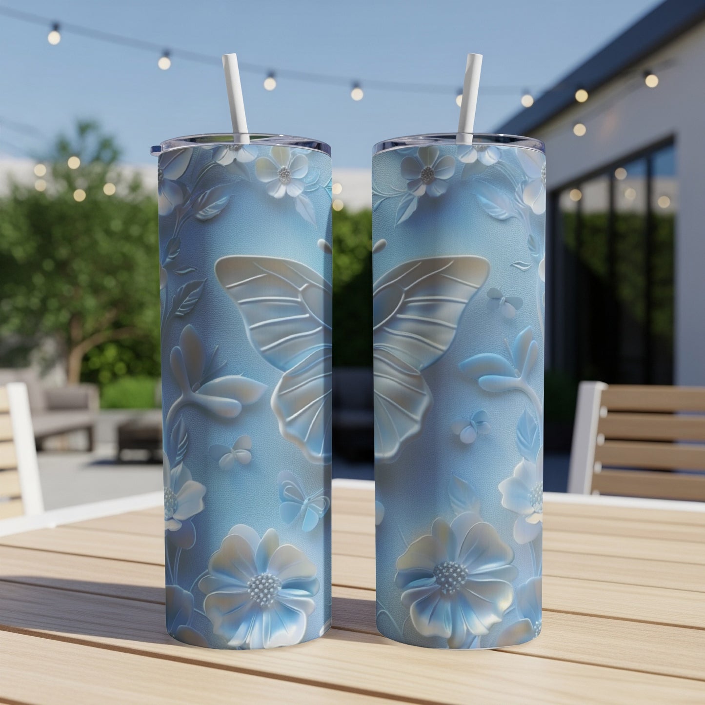 Two tall, light blue tumblers with a raised butterfly and floral pattern.