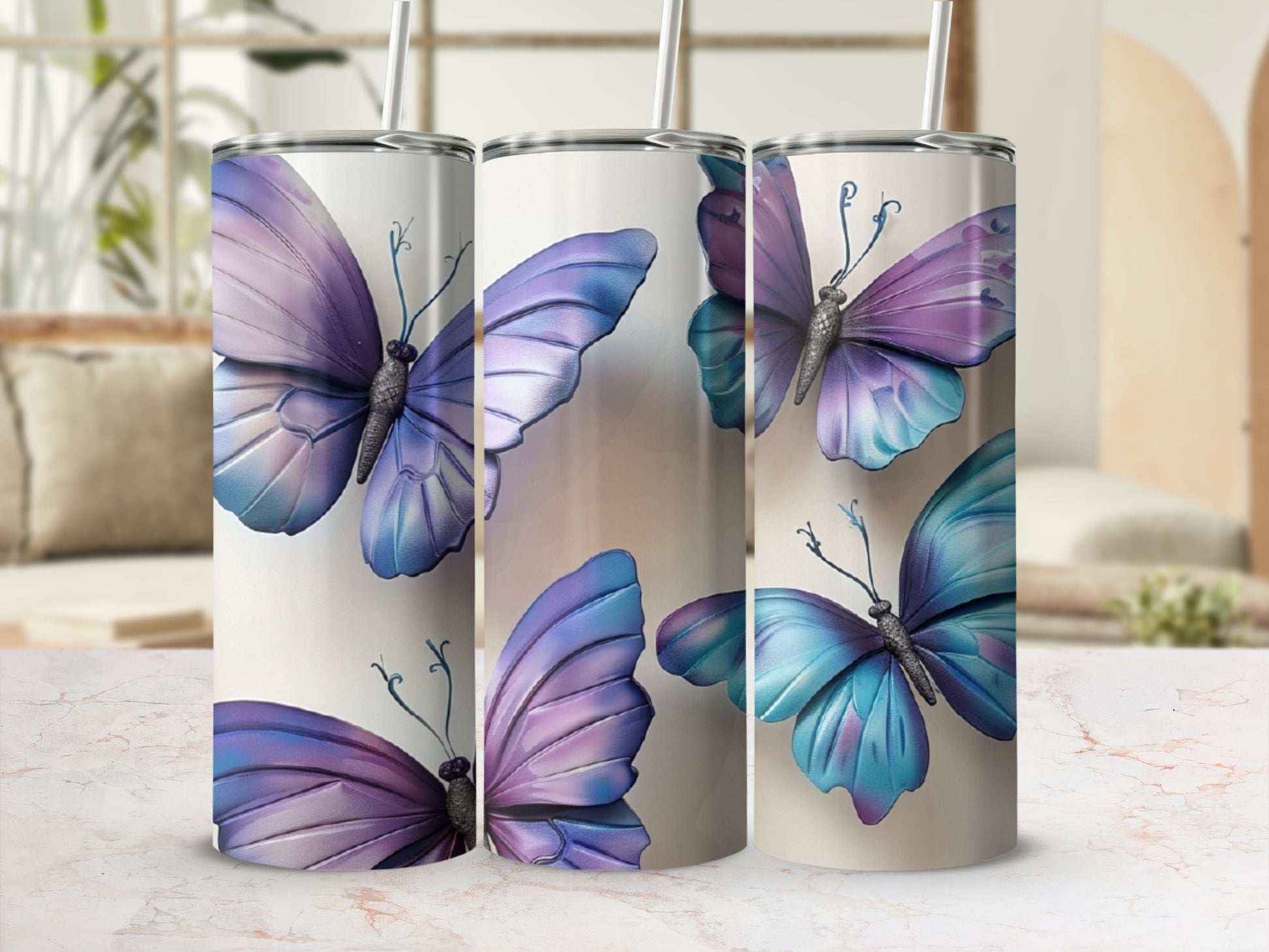 Purple and blue butterfly pattern on three white tumblers.