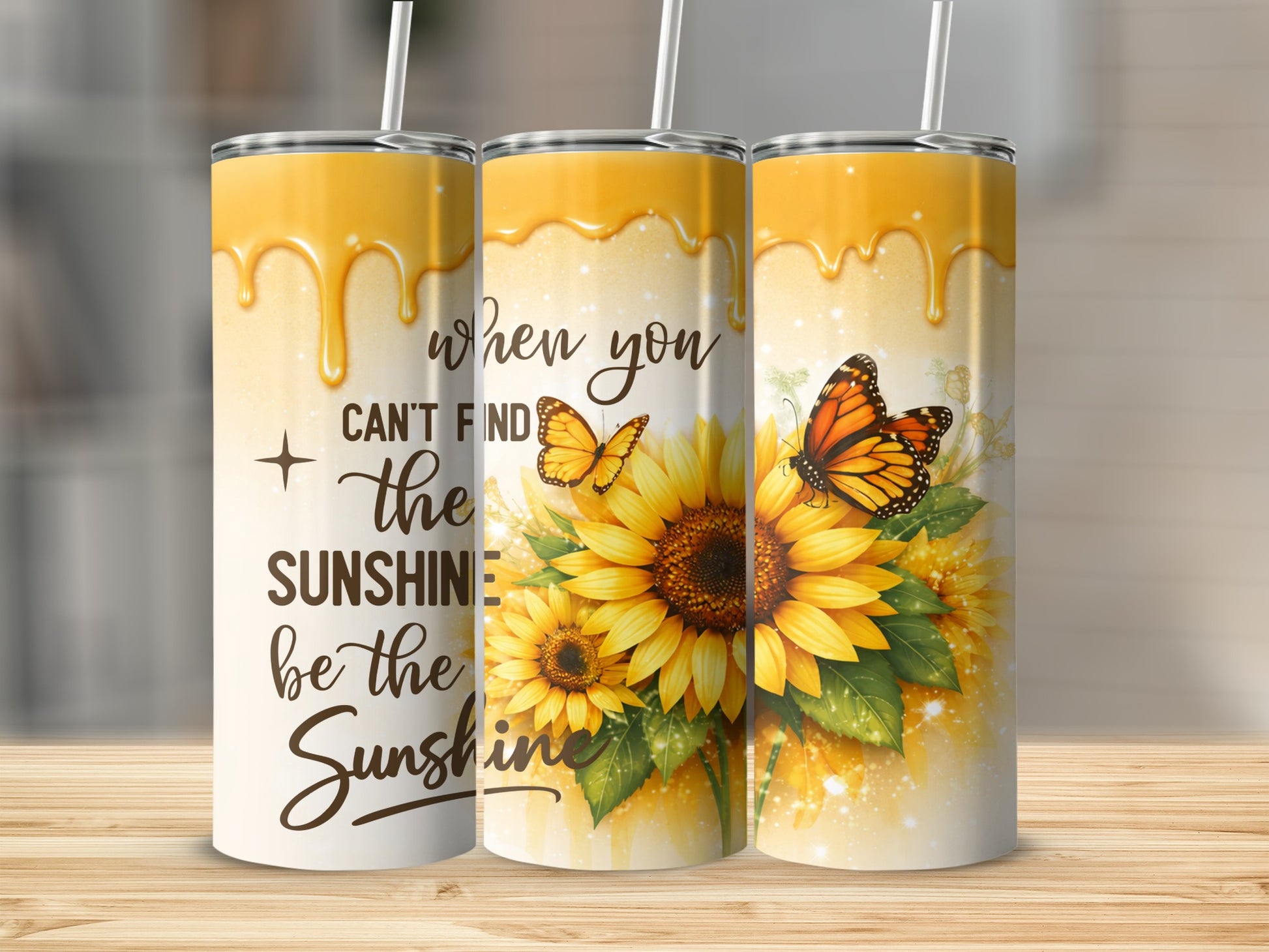 Three sunflowers and butterflies on tumblers with text "when you can't find the sunshine be the sunshine".