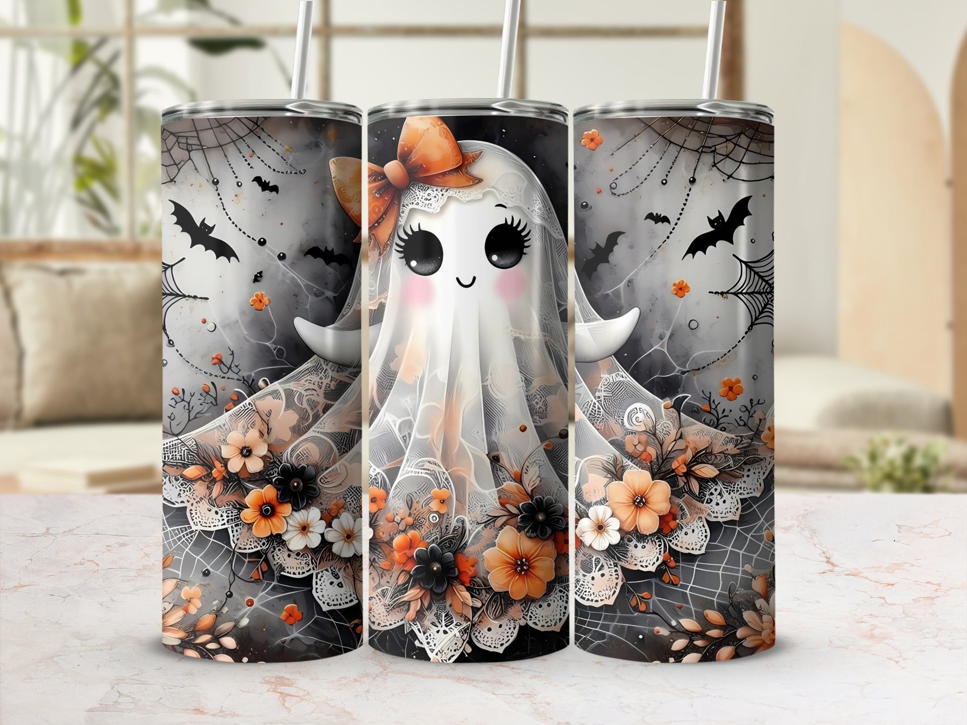 Three tumblers with a cute ghost, bats, and floral Halloween design.