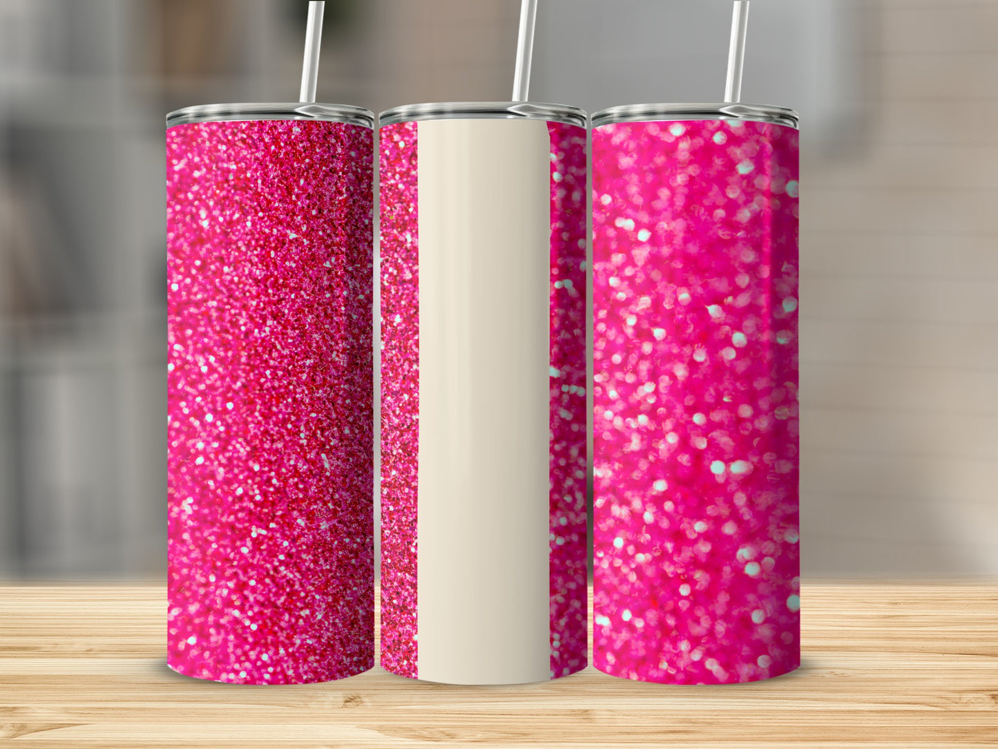 Three pink glitter tumblers with cream stripe detail on a wooden surface.