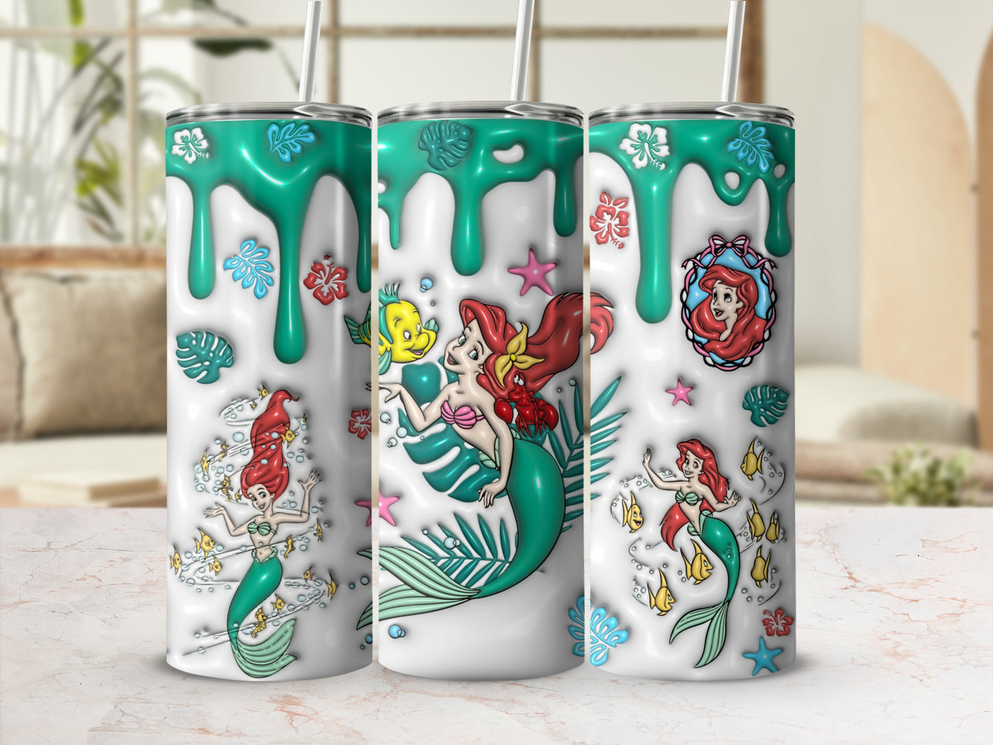 The Little Mermaid characters Ariel, Flounder, and Sebastian on a mint green tumbler.