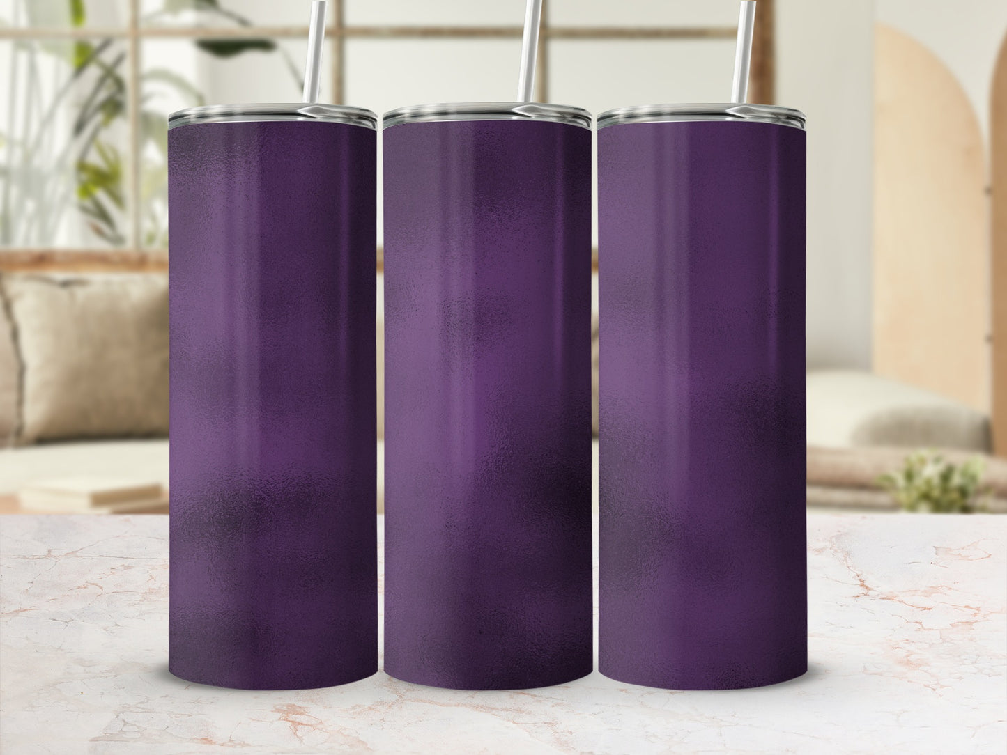 Three purple tumblers with straws on a marble surface.