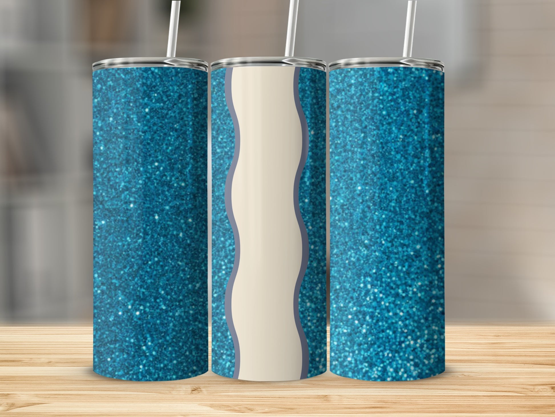 Three tall tumblers with blue glitter and wavy cream designs.