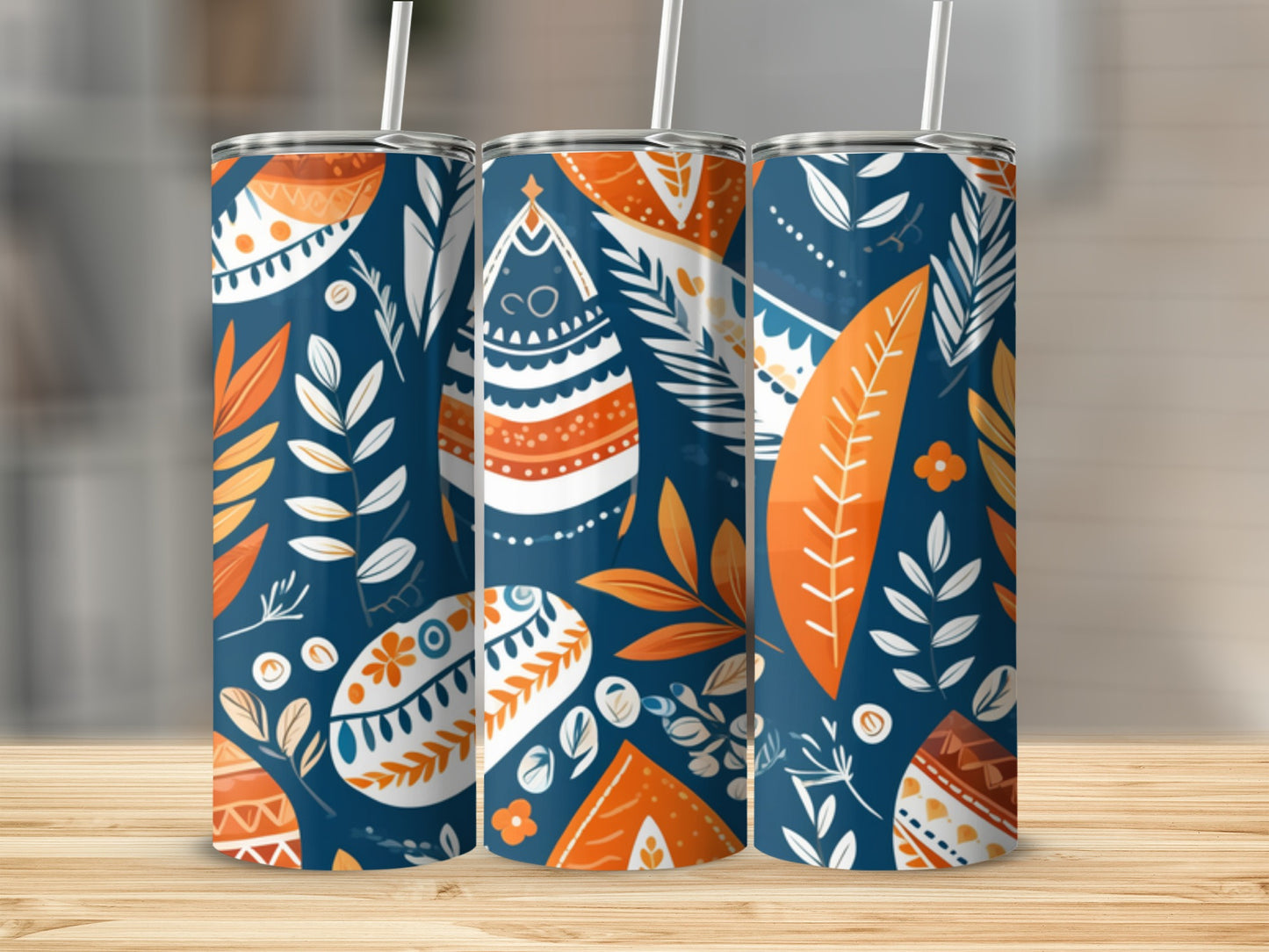 Tumbler with navy background and orange and white abstract floral pattern.