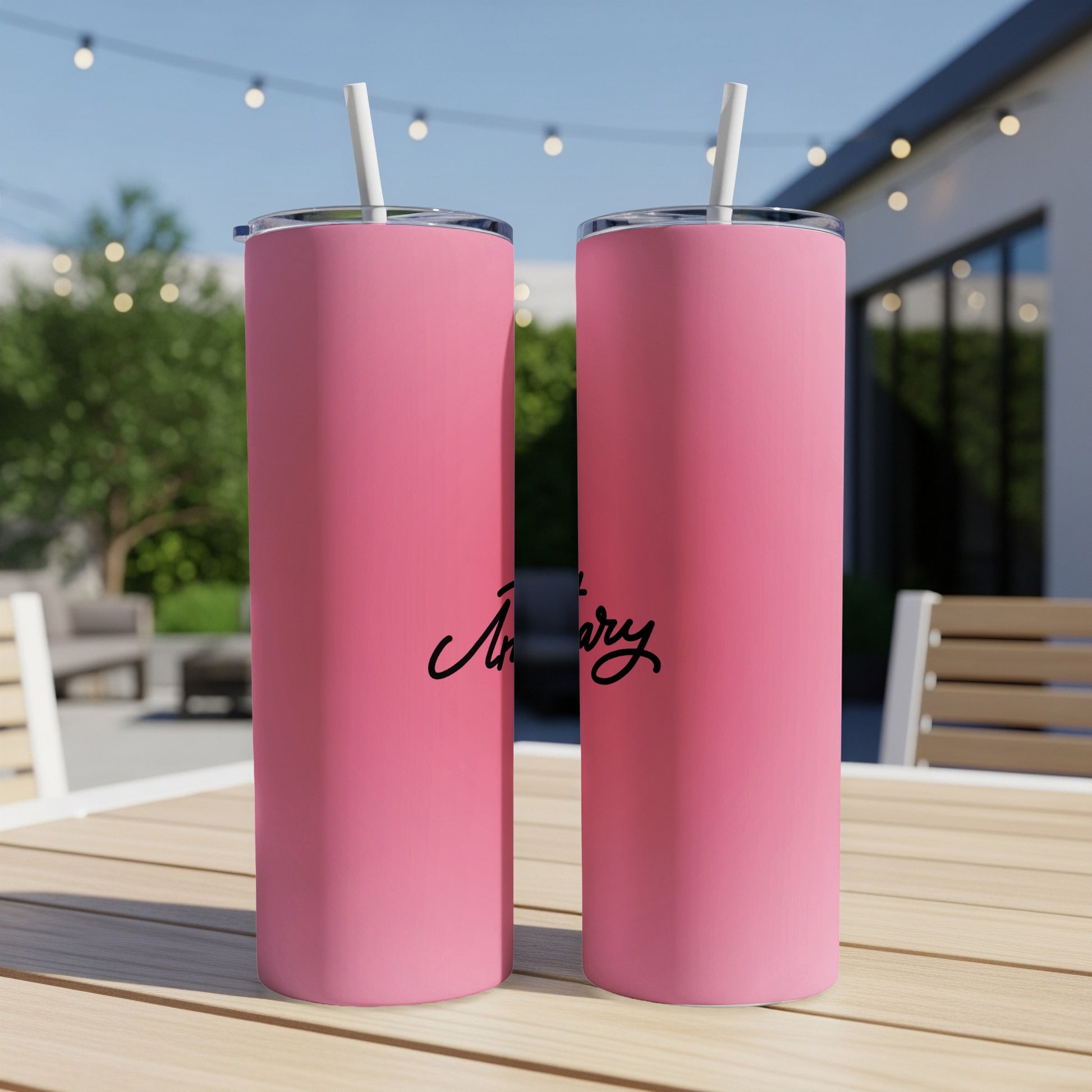 Pink tumbler with "Artizary" in black script on it.