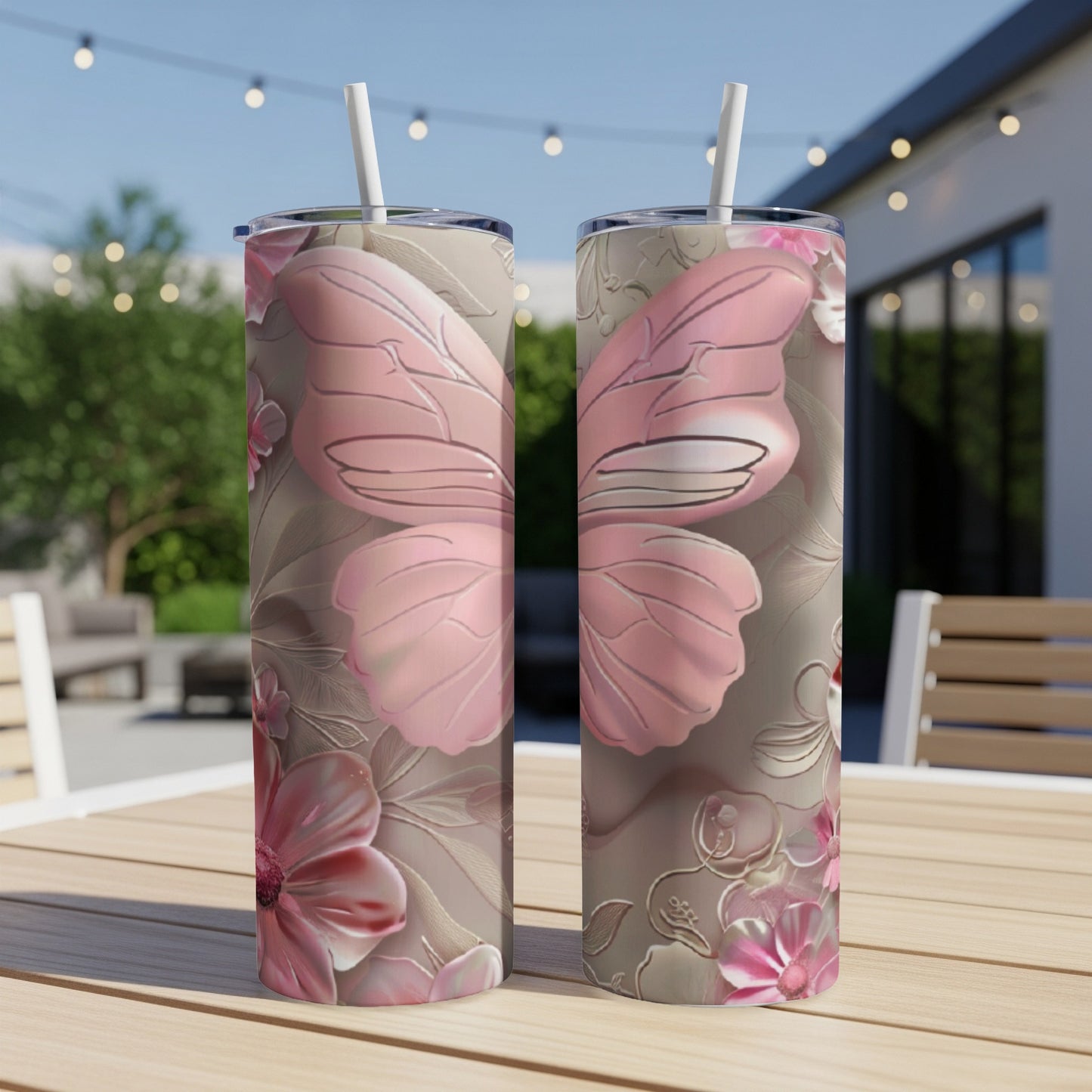 Two tall, pink and gray tumblers with butterfly wing and floral designs.