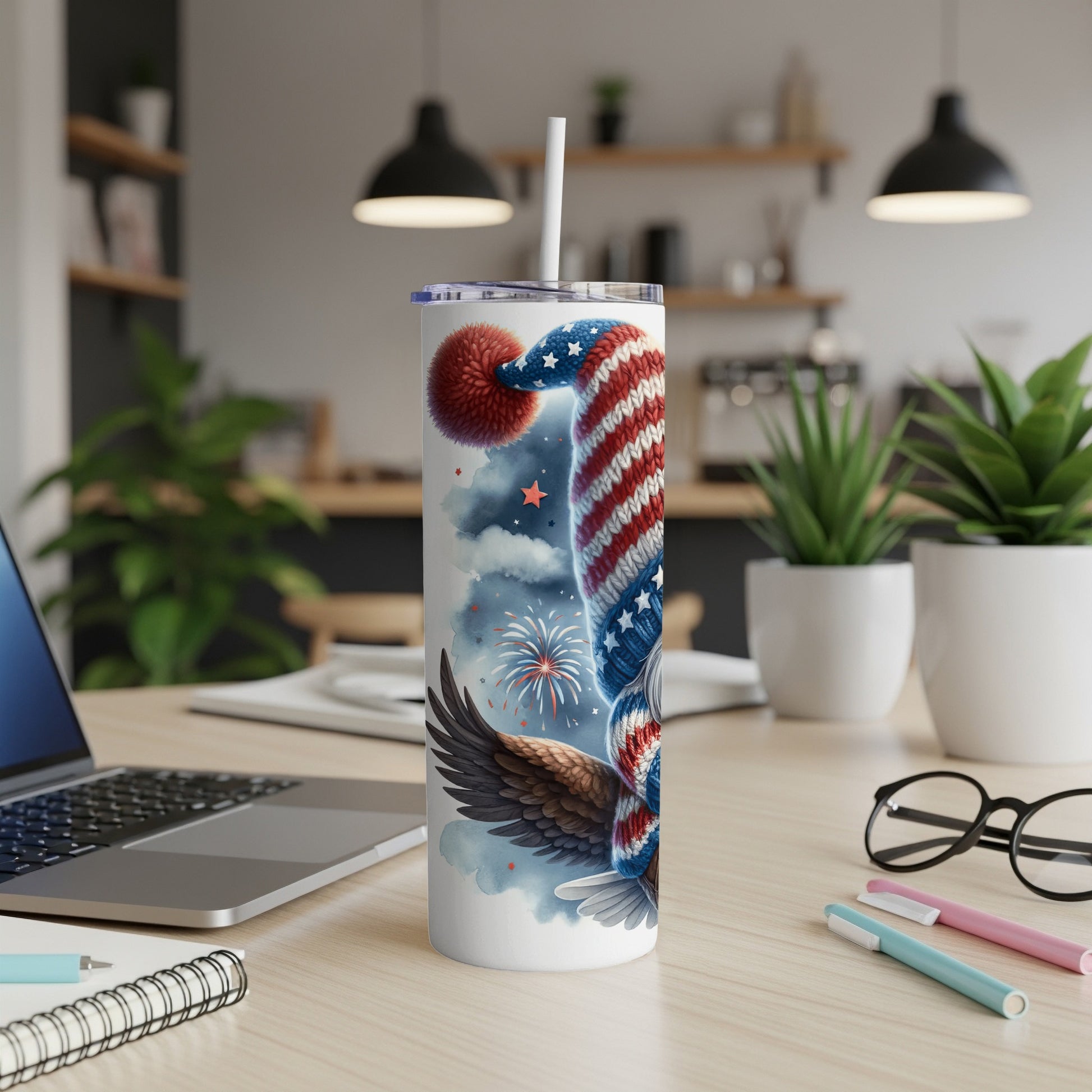 Patriotic tumbler with eagle and fireworks design, featuring a straw.