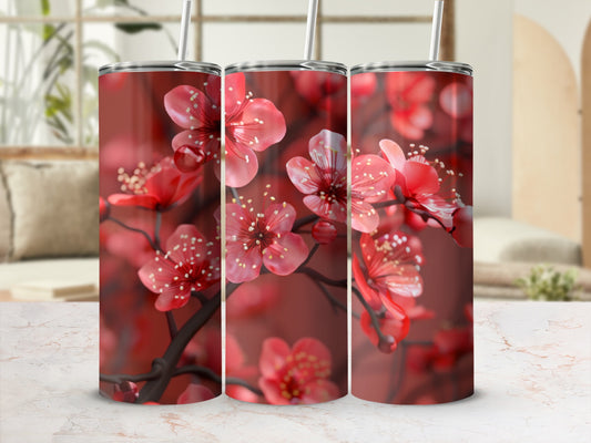 Red cherry blossoms on a tumbler with a marble countertop and blurred background.